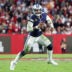 Jan 16, 2023; Tampa, Florida, USA; Dallas Cowboys quarterback Dak Prescott (4) runs with the ball against the Tampa Bay Buccaneers in the second quarter during a wild card game at Raymond James Stadium.