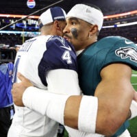Dec 10, 2023; Arlington, Texas, USA; Dallas Cowboys quarterback Dak Prescott (4) hugs Philadelphia Eagles quarterback Jalen Hurts (1) after the game at AT&T Stadium.