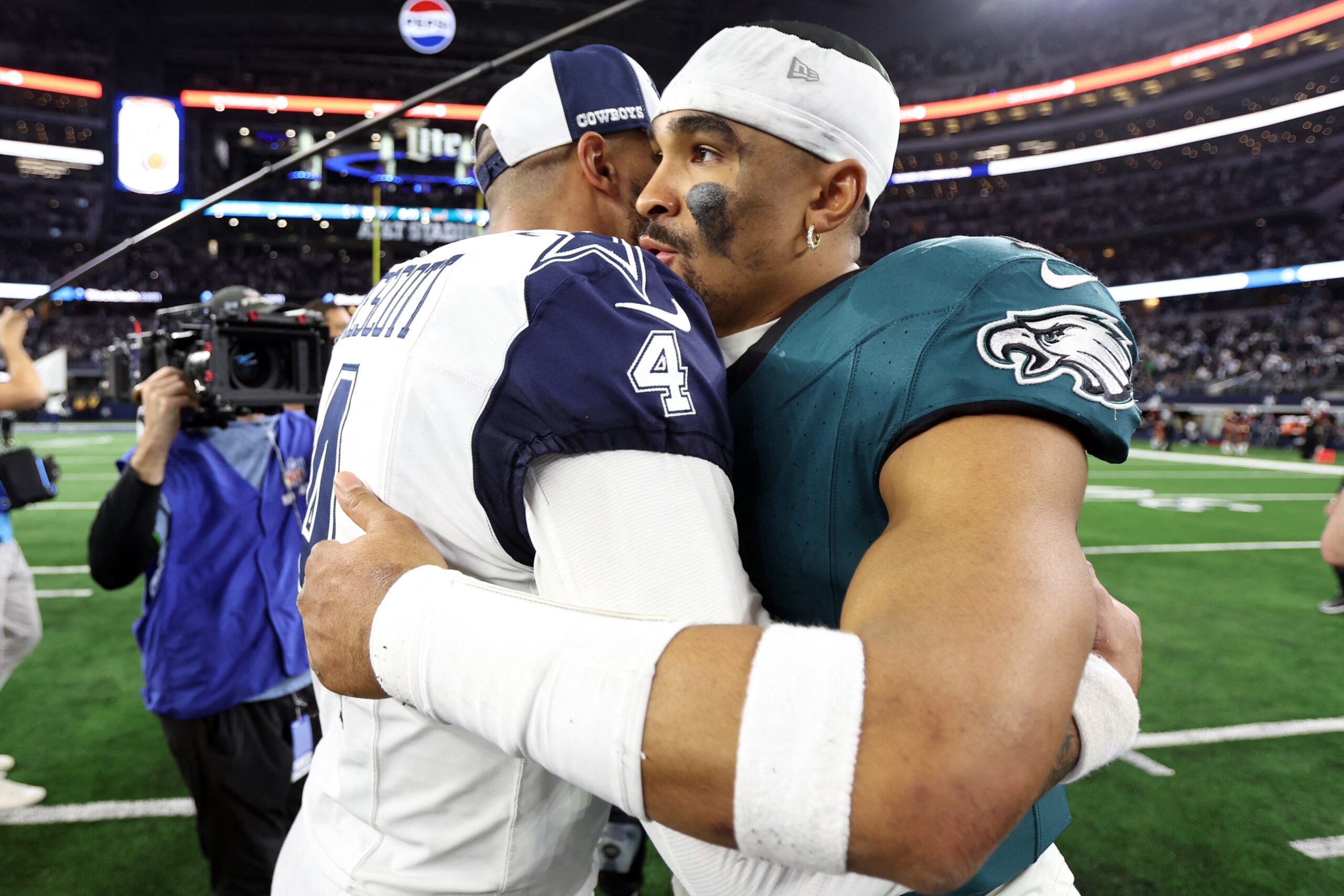 Dec 10, 2023; Arlington, Texas, USA; Dallas Cowboys quarterback Dak Prescott (4) hugs Philadelphia Eagles quarterback Jalen Hurts (1) after the game at AT&T Stadium.