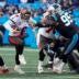 Jan 7, 2024; Charlotte, North Carolina, USA; Tampa Bay Buccaneers quarterback Baker Mayfield (6) keeps the ball and runs with Carolina Panthers defensive tackle Derrick Brown (95) reaching out for the attempted stop during the second half at Bank of America Stadium.