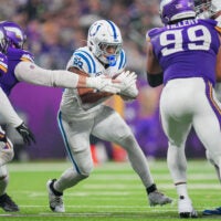 Nov 3, 2024; Minneapolis, Minnesota, USA; Indianapolis Colts running back Jonathan Taylor (28) runs with the ball against the Minnesota Vikings in the fourth quarter at U.S. Bank Stadium.