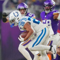 Nov 3, 2024; Minneapolis, Minnesota, USA; Indianapolis Colts running back Jonathan Taylor (28) runs with the ball against the Minnesota Vikings in the fourth quarter at U.S. Bank Stadium.