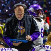 Jan 5, 2025; Detroit, Michigan, USA; Minnesota Vikings Assistant Head Coach / Outside Linebackers Mike Pettine talks to players on the bench during the first half of the game against the Detroit Lions at Ford Field.