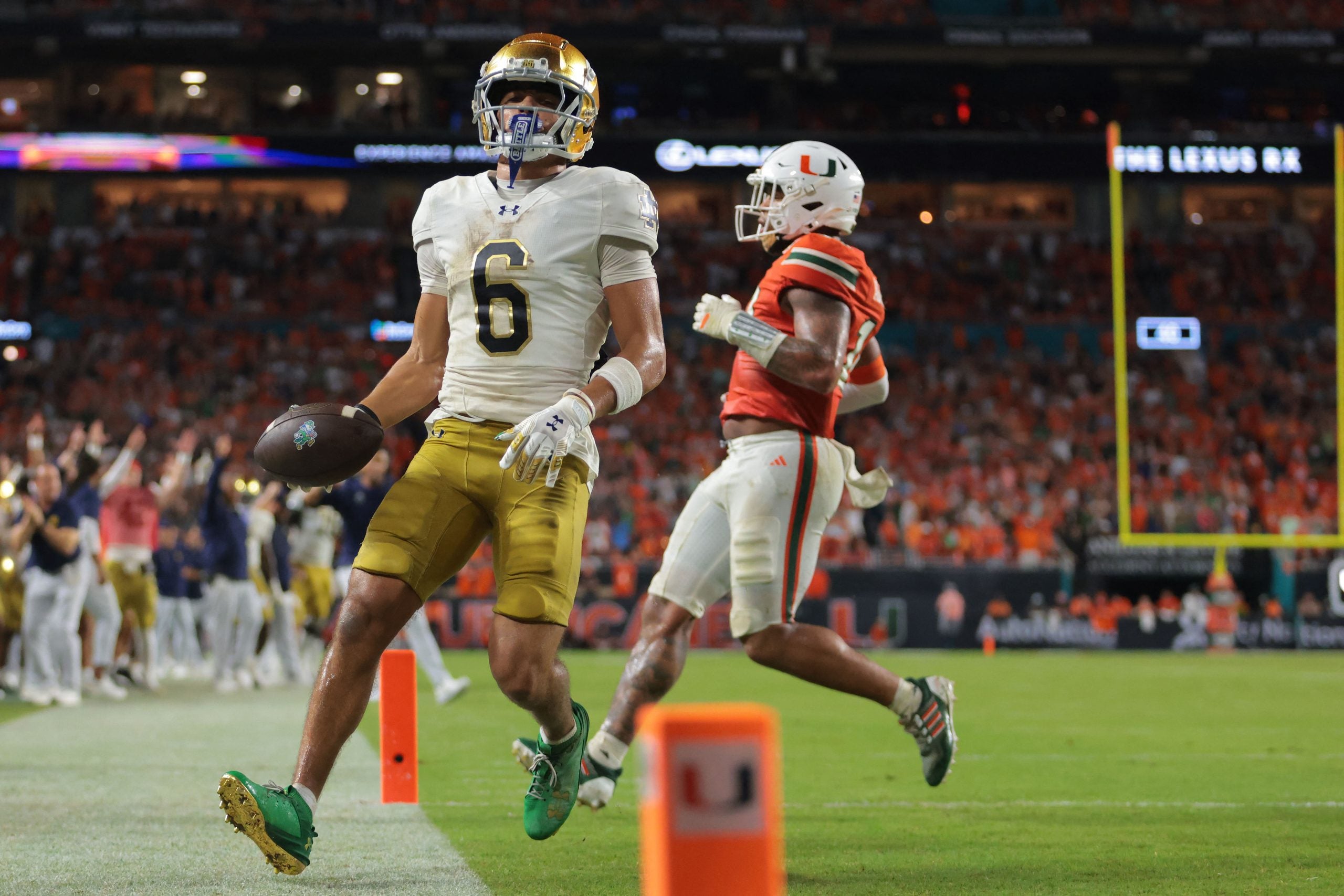 Aug 31, 2025; Miami Gardens, Florida, USA; Notre Dame Fighting Irish wide receiver Jordan Faison (6) scores a touchdown against the Miami Hurricanes during the third quarter at Hard Rock Stadium.