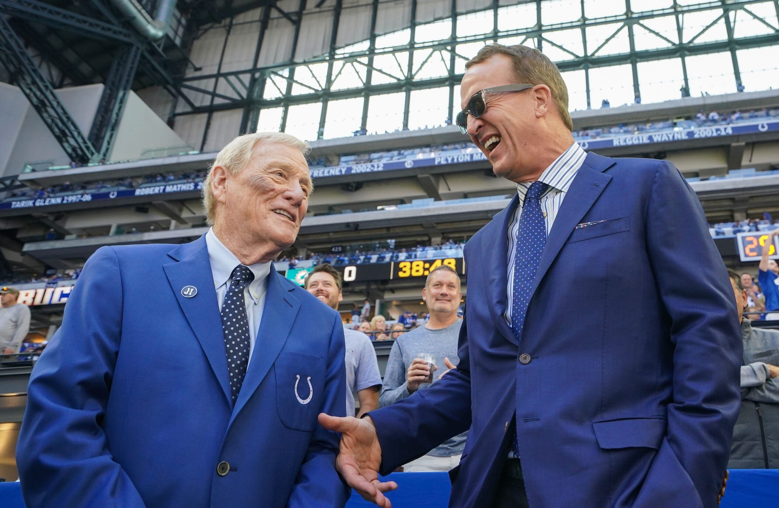 Sep 7, 2025; Indianapolis, Indiana, USA; Peyton Manning talks with NFL analyst Bill Polian before the game between the Miami Dolphins and the Indianapolis Colts at Lucas Oil Stadium.