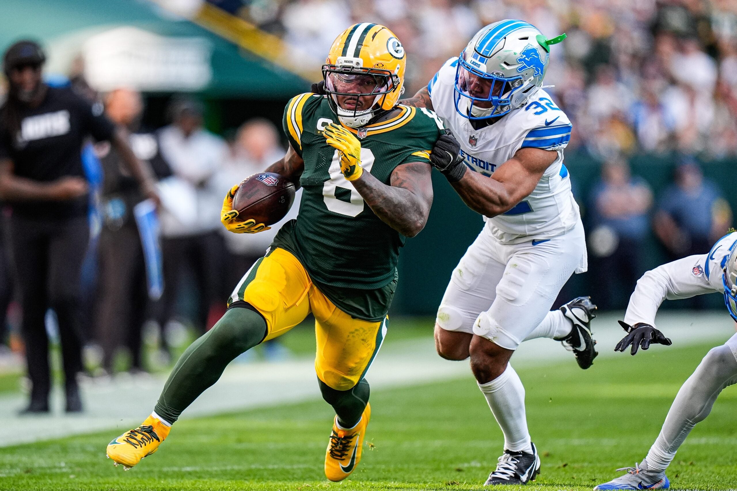 Detroit Lions safety Brian Branch (32) tackles Green Bay Packers running back Josh Jacobs (8) during the second half at Lambeau Field in Green Bay, Wis., on Sunday, September 7, 2025.
