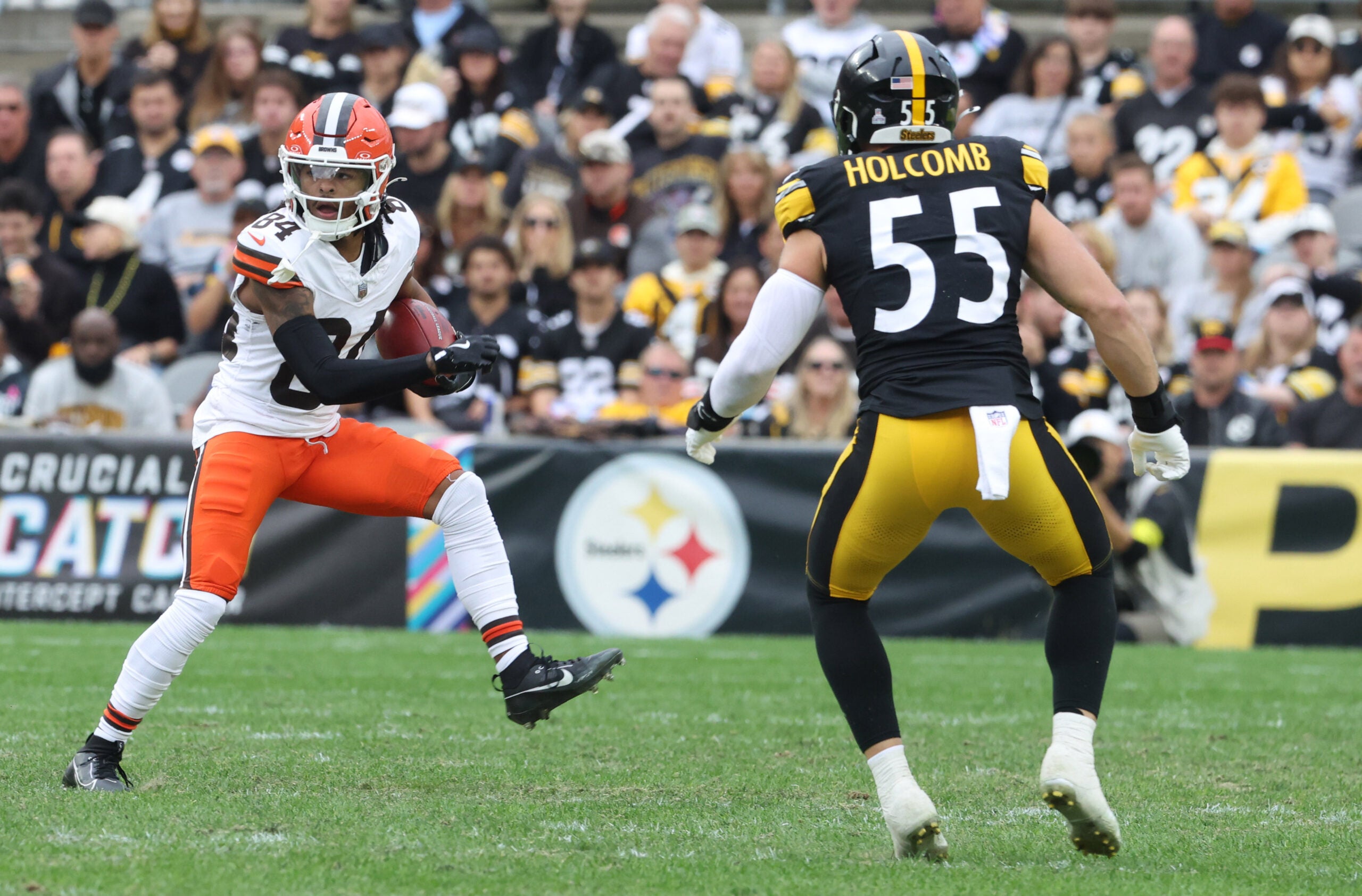 Oct 12, 2025; Pittsburgh, Pennsylvania, USA; Cleveland Browns wide receiver Gage Larvadain (84) runs after a catch as Pittsburgh Steelers linebacker Cole Holcomb (55) chases during the third quarter at Acrisure Stadium.