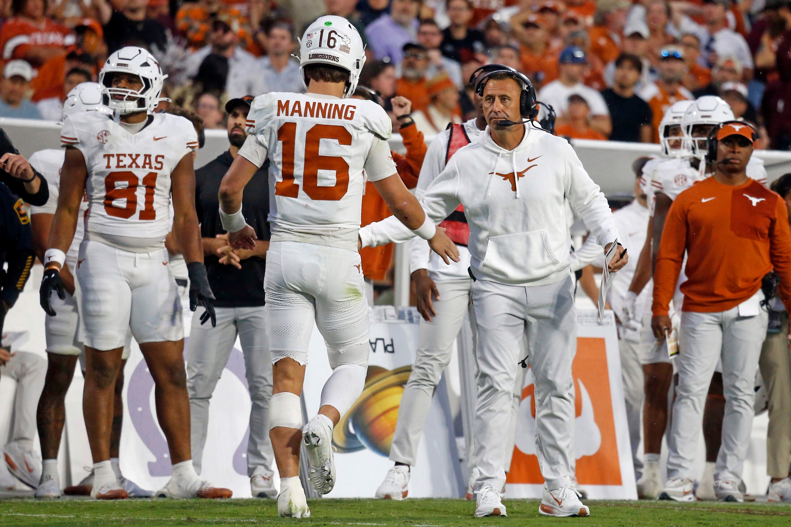 Oct 25, 2025; Starkville, Mississippi, USA; Texas Longhorns head coach Steve Sarkisian reacts with Texas Longhorns quarterback Arch Manning (16) during the fourth quarter against the Mississippi State Bulldogs at Davis Wade Stadium at Scott Field.