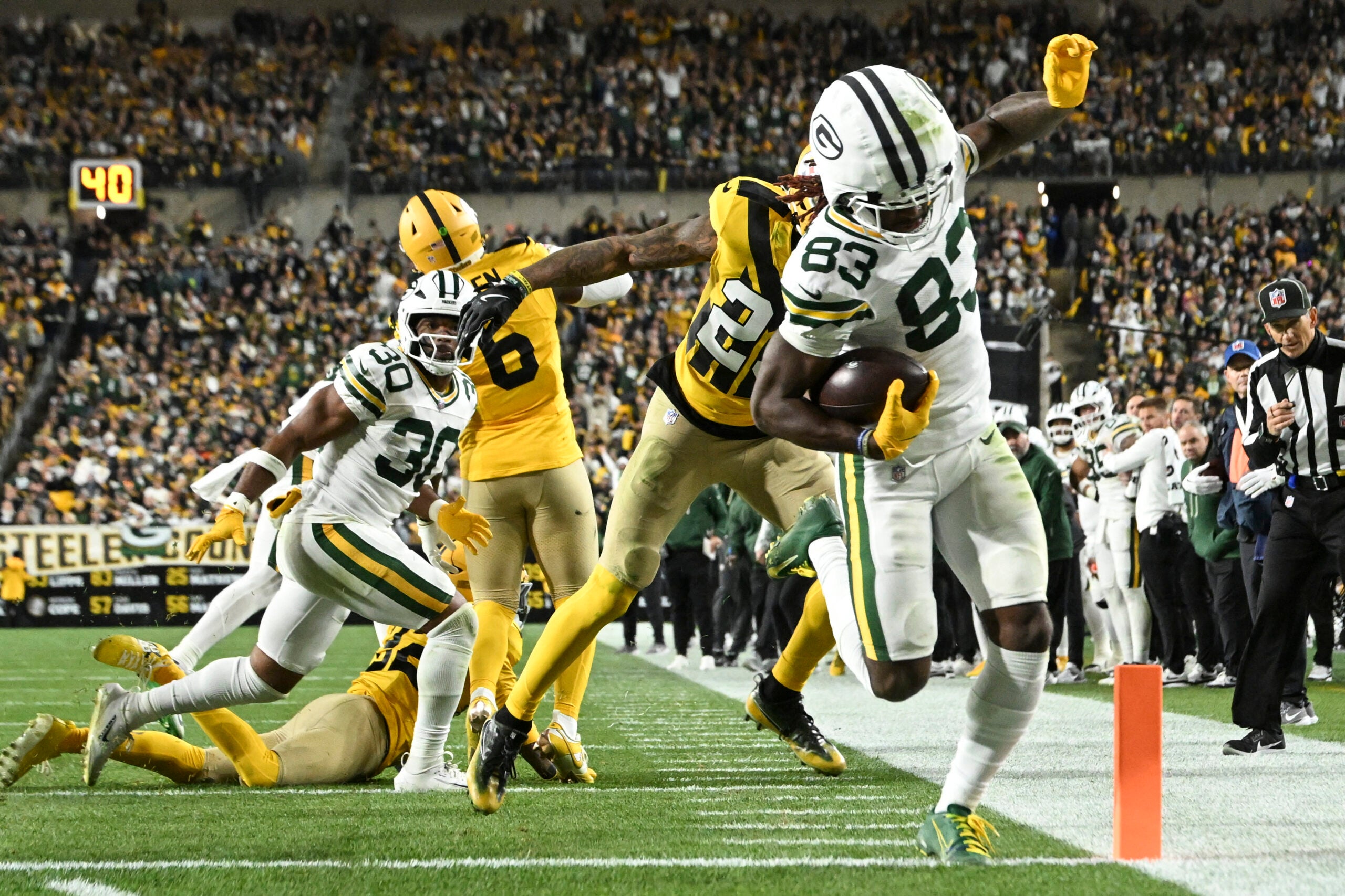 Oct 26, 2025; Pittsburgh, Pennsylvania, USA; Green Bay Packers wide receiver Savion Williams (83) scores a touchdown against Pittsburgh Steelers cornerback Darius Slay (23) during the third quarter at Acrisure Stadium.