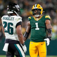 Nov 10, 2025; Green Bay, Wisconsin, USA; Green Bay Packers defensive end Micah Parsons (1) talks with running back Saquon Barkley (26) during the game at Lambeau Field.