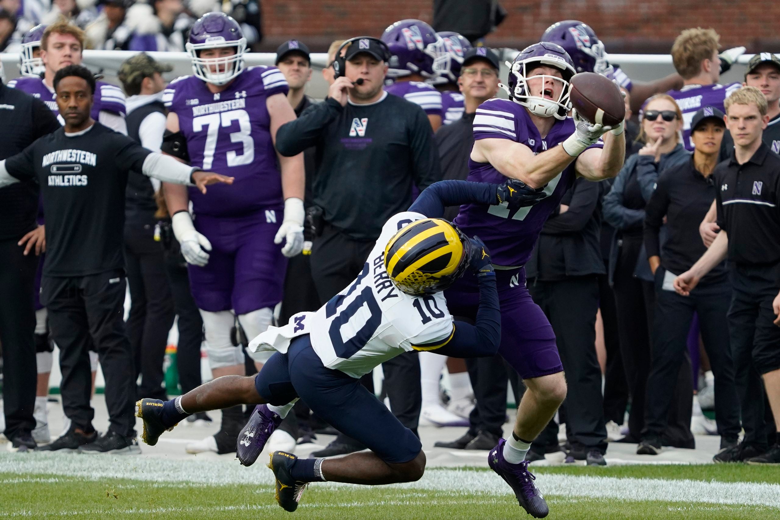 Nov 15, 2025; Chicago, Illinois, USA; Michigan Wolverines defensive back Zeke Berry (10) defends Northwestern Wildcats wide receiver Griffin Wilde (17) as he tries to make a catch during the first half at Wrigley Field.