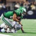 Nov 23, 2025; Arlington, Texas, USA; Philadelphia Eagles running back Saquon Barkley (26) is brought down by Dallas Cowboys linebacker DeMarvion Overshown (0) in the fourth quarter at AT&T Stadium.
