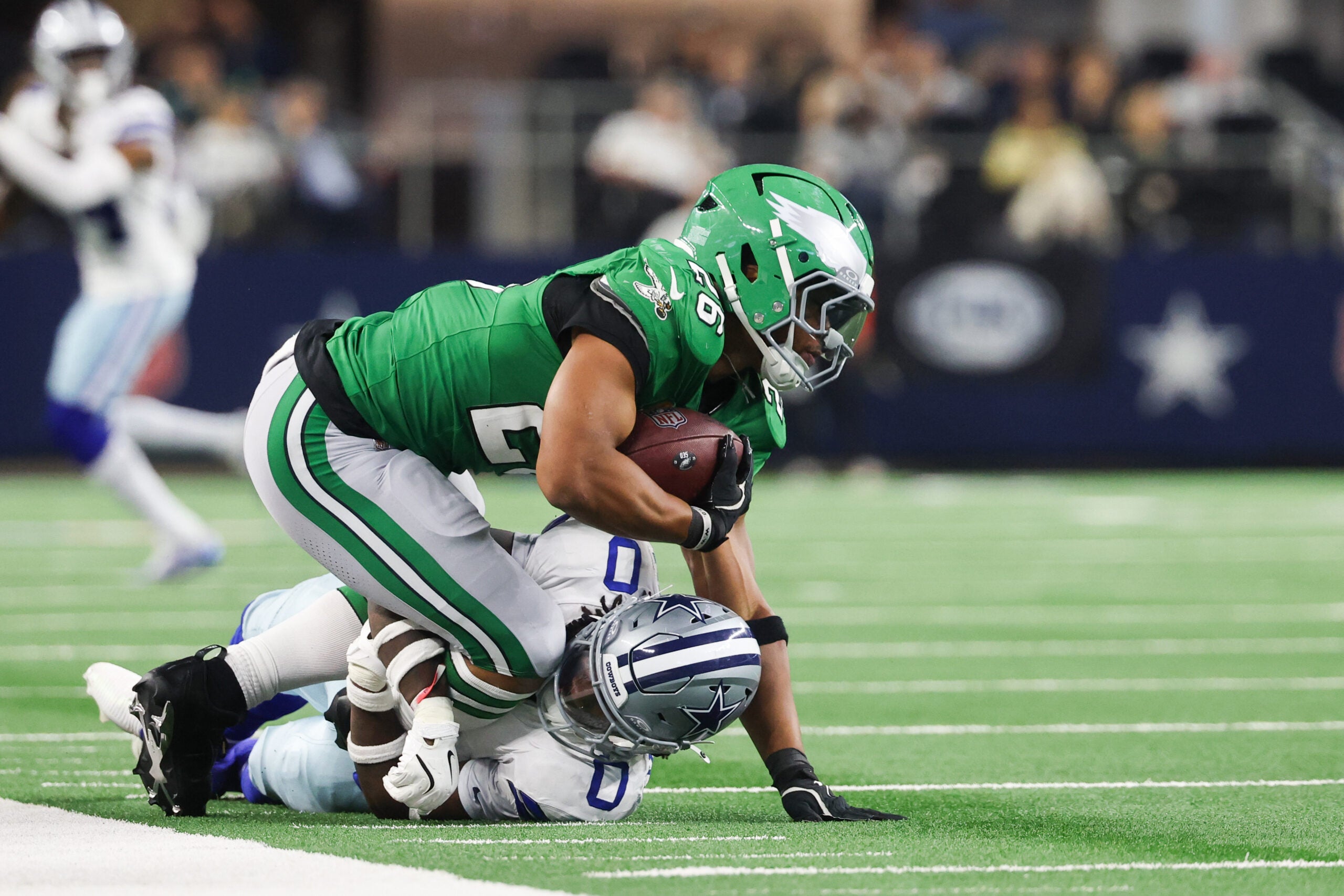 Nov 23, 2025; Arlington, Texas, USA; Philadelphia Eagles running back Saquon Barkley (26) is brought down by Dallas Cowboys linebacker DeMarvion Overshown (0) in the fourth quarter at AT&T Stadium.
