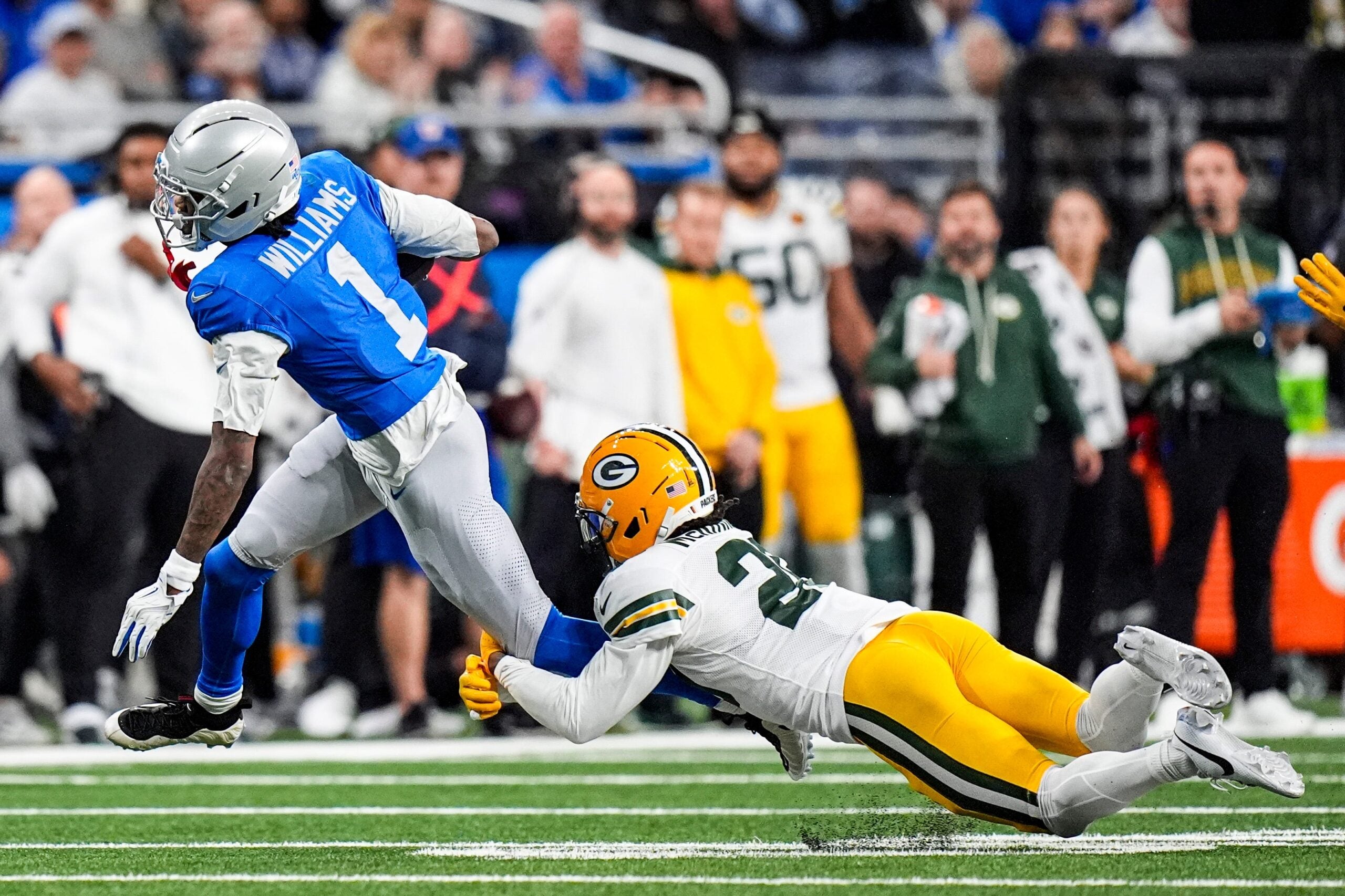 Detroit Lions wide receiver Jameson Williams (1) makes a catch against Green Bay Packers safety Xavier McKinney (29) during the first half at Ford Field in Detroit on Thursday, Nov. 27, 2025.