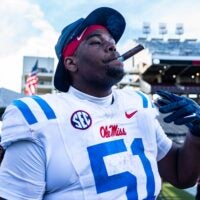 Ole Miss defensive lineman Zxavian Harris (51) smokes a cigar after a college football game between Mississippi State and Ole Miss at Davis Wade Stadium in Starkville, Miss., on Friday, Nov. 28, 2025. Ole Miss defeated Mississippi State 38-19 in the Egg Bowl.