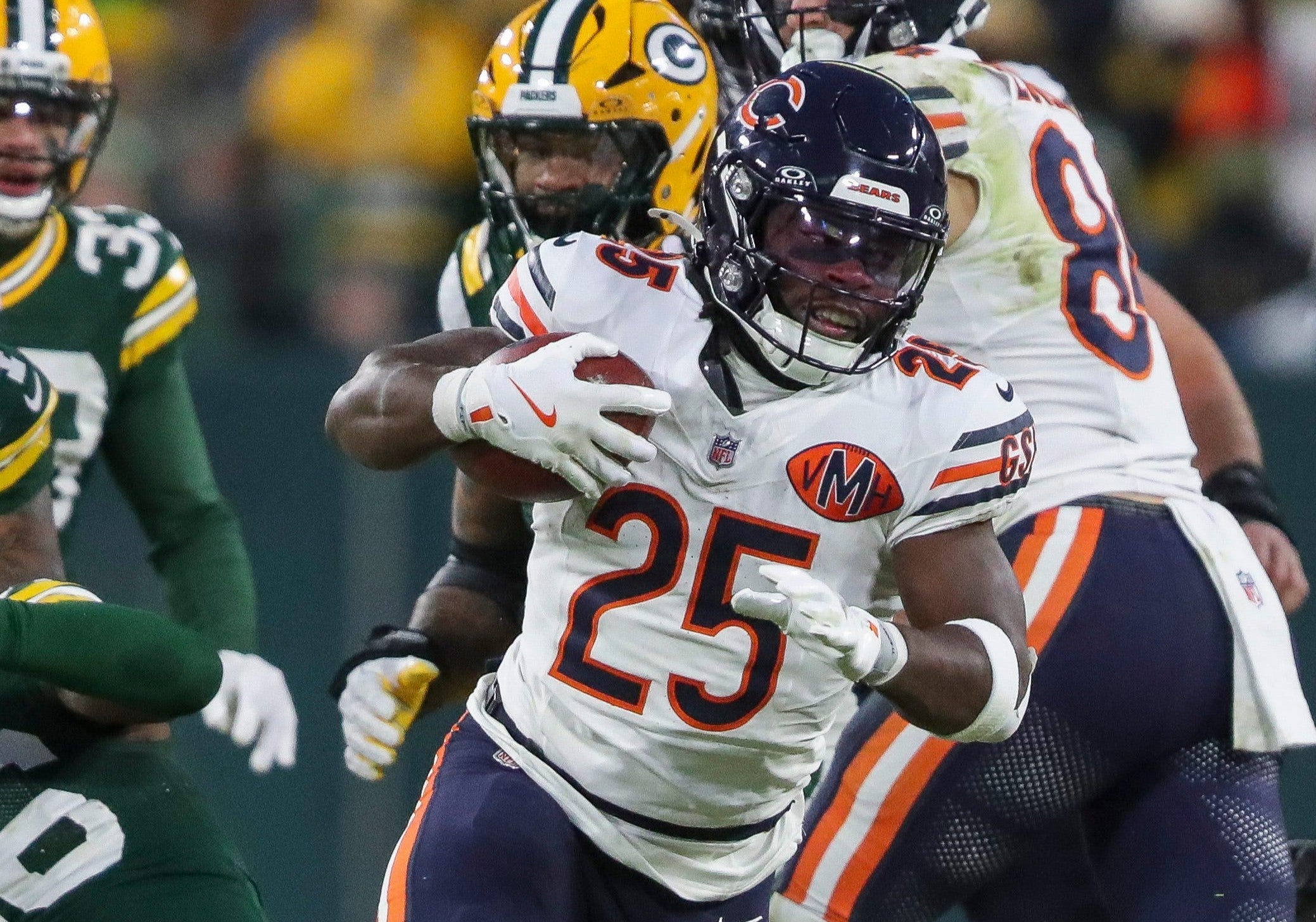 Chicago Bears running back Kyle Monangai (25) breaks out of a tackle by Green Bay Packers linebacker Edgerrin Cooper (56) on Sunday, December 7, 2025, at Lambeau Field in Green Bay, Wis. The Packers won the game, 28-21.