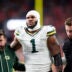 Dec 14, 2025; Denver, Colorado, USA; Green Bay Packers defensive end Micah Parsons (1) walks off the field with help from medical personnel following an injury during the third quarter against the Denver Broncos at Empower Field at Mile High.