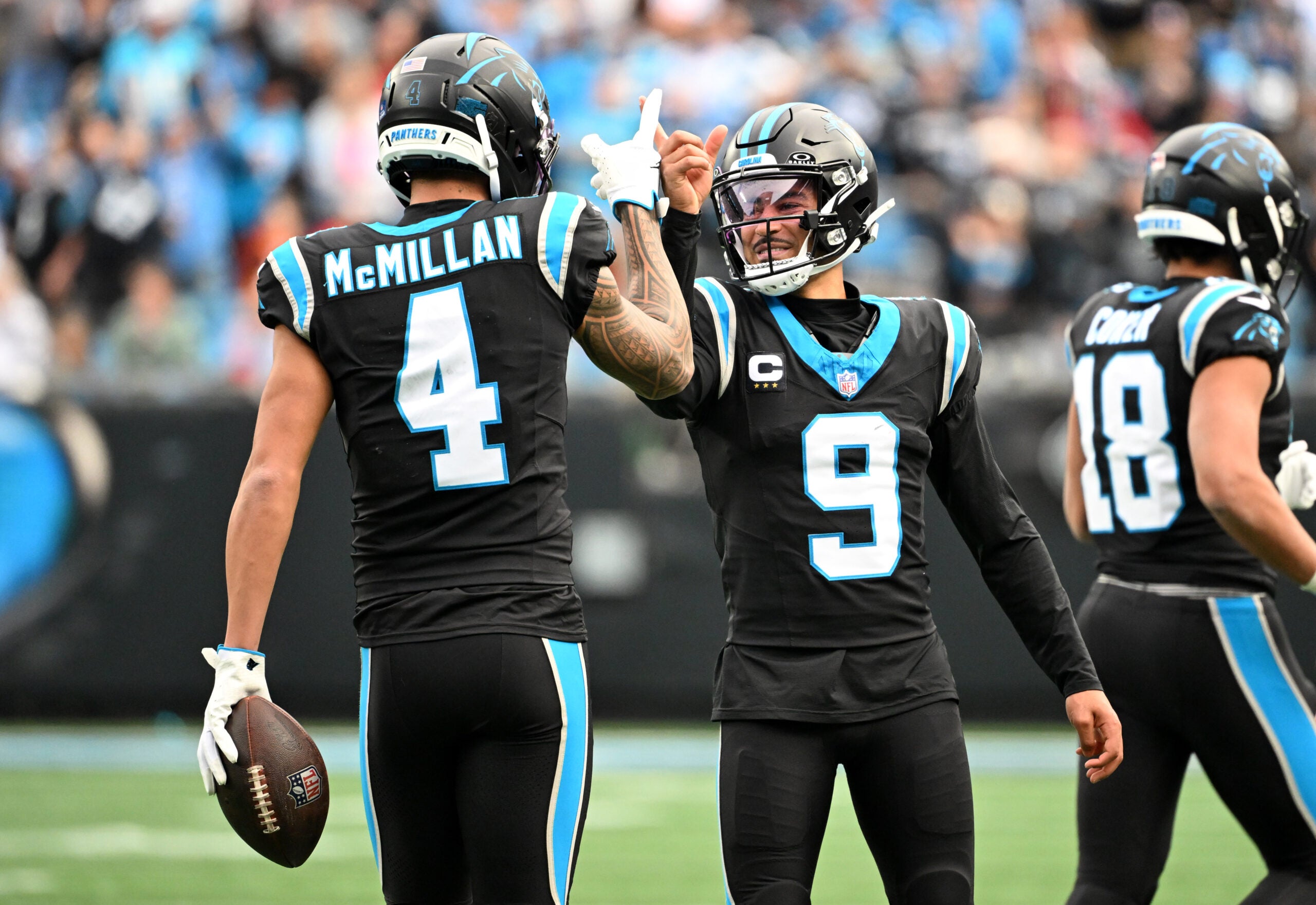 Dec 21, 2025; Charlotte, North Carolina, USA; Carolina Panthers quarterback Bryce Young (9) celebrates with wide receiver Tetairoa McMillan (4) after a play during the first half against the Tampa Bay Buccaneers at Bank of America Stadium.