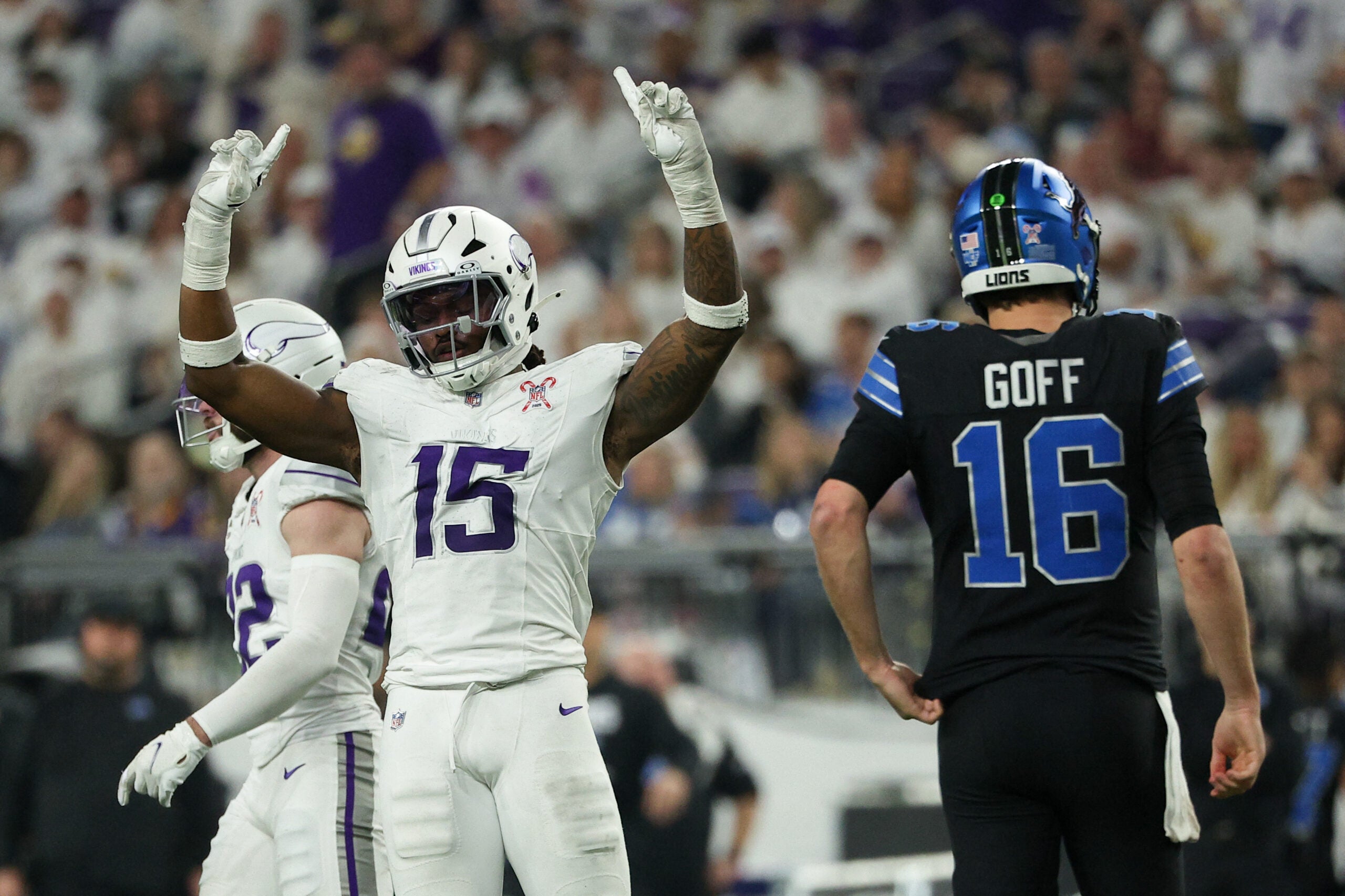 Dec 25, 2025; Minneapolis, Minnesota, USA; Minnesota Vikings linebacker Dallas Turner (15) celebrates after a play as Detroit Lions quarterback Jared Goff (16) reacts in the second half at U.S. Bank Stadium.
