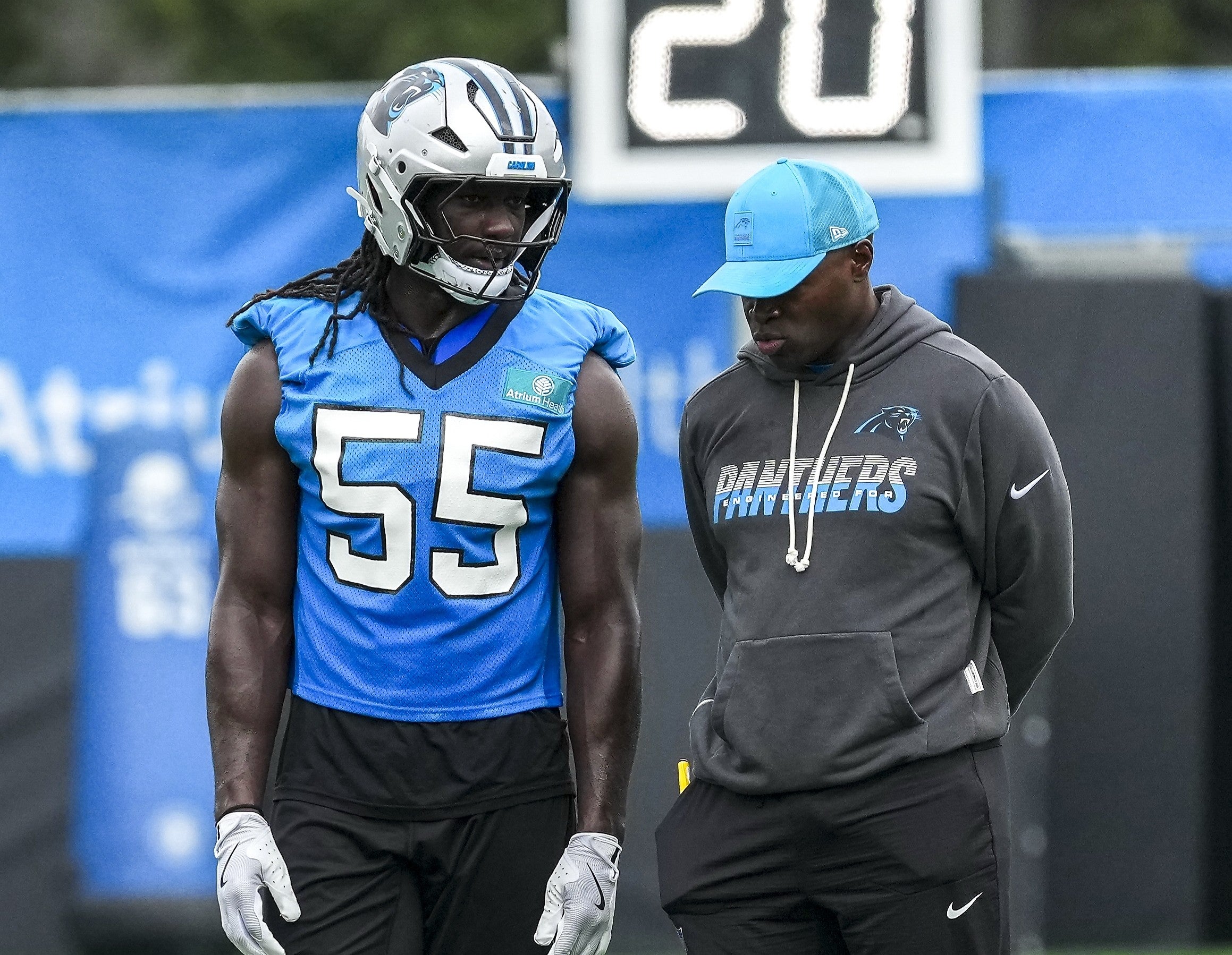 Aug 4, 2026; Charlotte, NC, USA; Carolina Panthers linebacker Devin Lloyd (55) chats with defensive coordinator Ejiro Evero during training camp at Bank of America Stadium. Mandatory Credit: Jim Dedmon-Imagn Images
