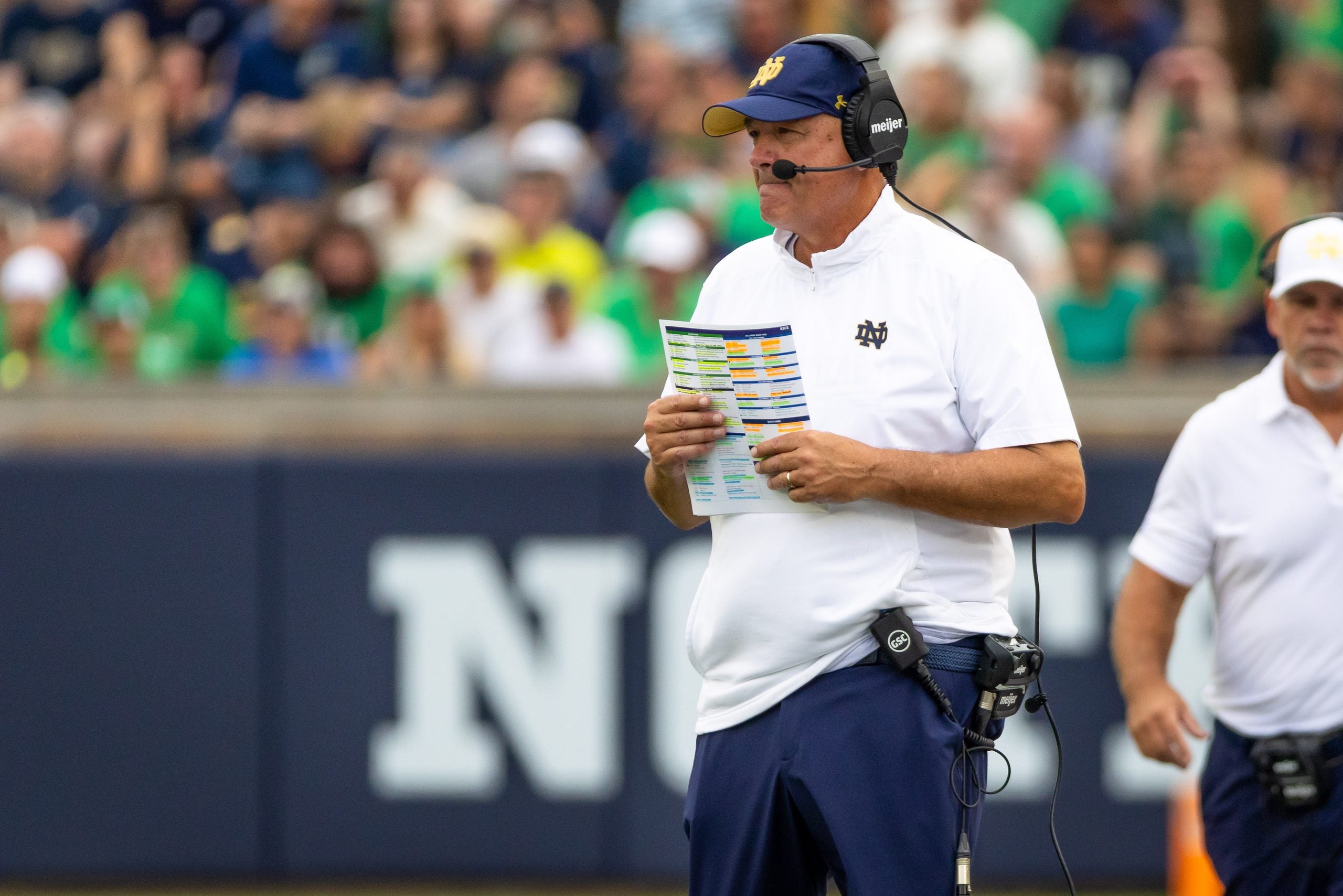 Sep 12, 2026; South Bend, Indiana, USA; Notre Dame Fighting Irish offensive coordinator Mike Denbrock watches from the sidelines against the Rice Owls during the second half at Notre Dame Stadium.