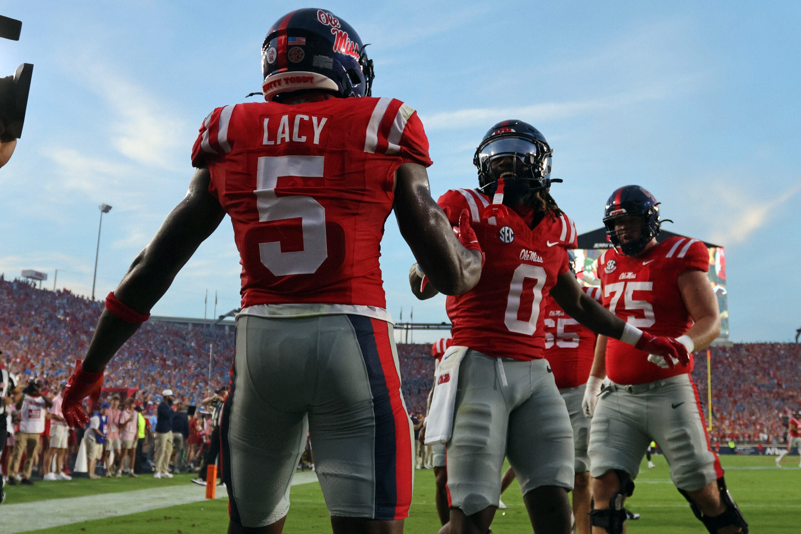 Sep 12, 2026; Oxford, Mississippi, USA; Mississippi Rebels wide receiver Johntay Cook II (0) reacts with running back Kewan Lacy (5) after a touchdown during the first quarter against the Charlotte 49ers at Vaught-Hemingway Stadium.