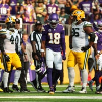 Sep 13, 2026; Minneapolis, Minnesota, USA; Minnesota Vikings wide receiver Justin Jefferson (18) carries Minnesota Vikings quarterback Kyler Murray (1) helmet off the field after a play during the first half against the Green Bay Packers at U.S. Bank Stadium.