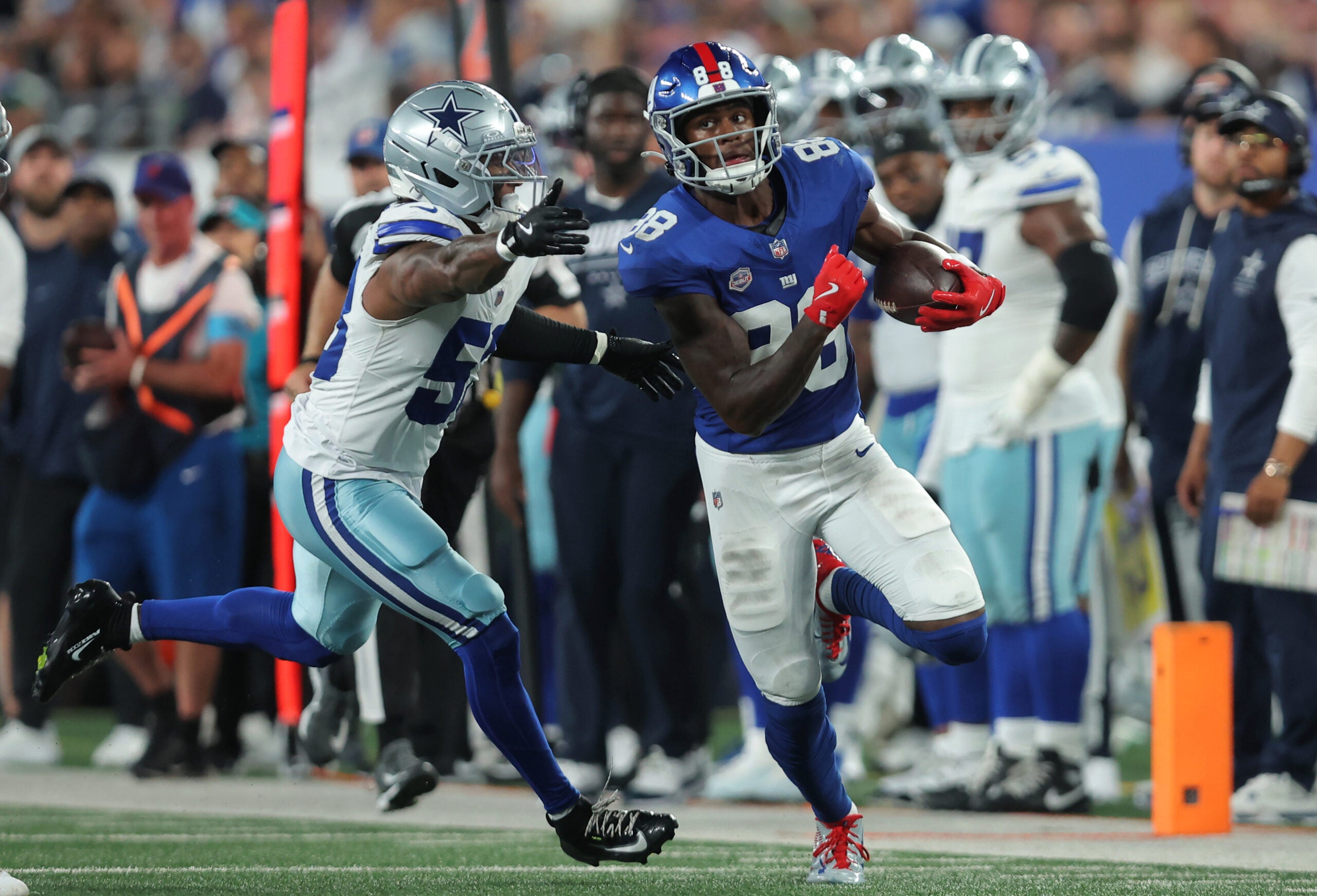 Sep 13, 2026; East Rutherford, New Jersey, USA; New York Giants wide receiver Malachi Fields (88) carries the ball defended by Dallas Cowboys linebacker Dee Winters (53) during the second quarter at MetLife Stadium.