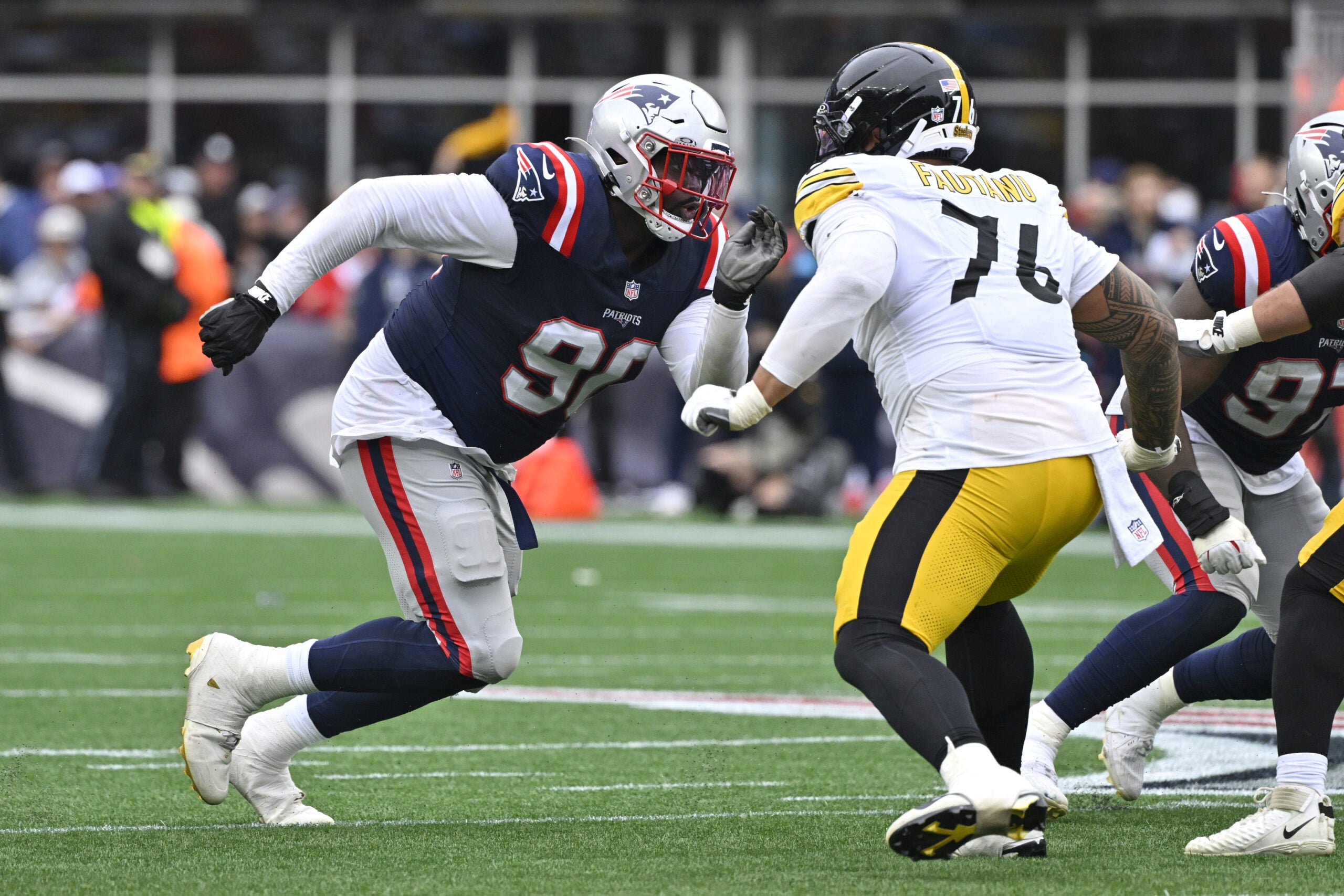Sep 20, 2026; Foxborough, Massachusetts, USA; New England Patriots defensive tackle Christian Barmore (90) is defended by Pittsburgh Steelers offensive tackle Troy Fautanu (76) in the second half at Gillette Stadium.