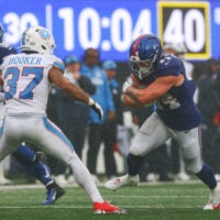 Sep 27, 2026; East Rutherford, New Jersey, USA; New York Giants running back Cam Skattebo (44) carries the ball as Tennessee Titans safety Amani Hooker (37) defends at MetLife Stadium. Mandatory Credit: Vincent Carchietta-Imagn Images