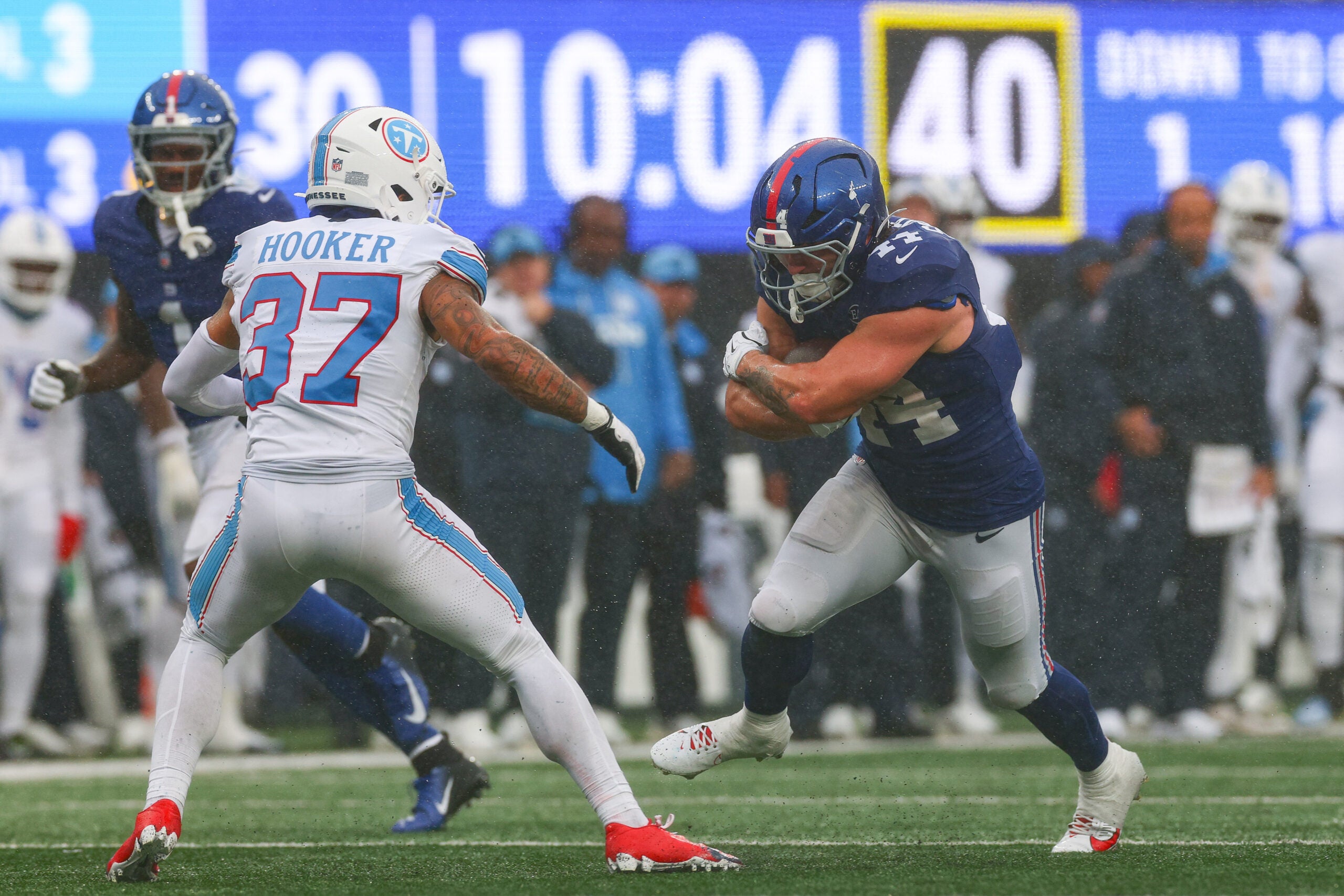 Sep 27, 2026; East Rutherford, New Jersey, USA; New York Giants running back Cam Skattebo (44) carries the ball as Tennessee Titans safety Amani Hooker (37) defends at MetLife Stadium. Mandatory Credit: Vincent Carchietta-Imagn Images
