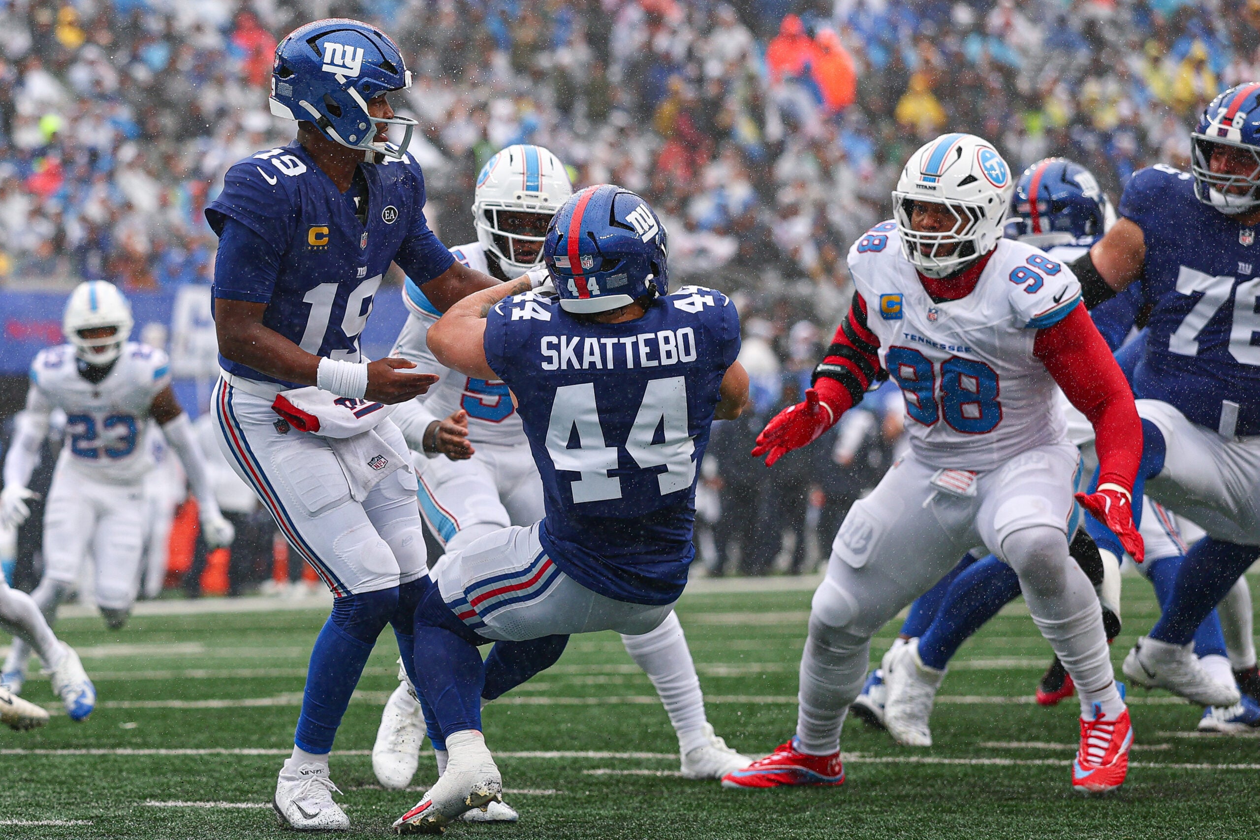 Sep 27, 2026; East Rutherford, New Jersey, USA; New York Giants running back Cam Skattebo (44) stumbles after colliding with quarterback Jameis Winston (19) during the first half against the Tennessee Titans at MetLife Stadium.