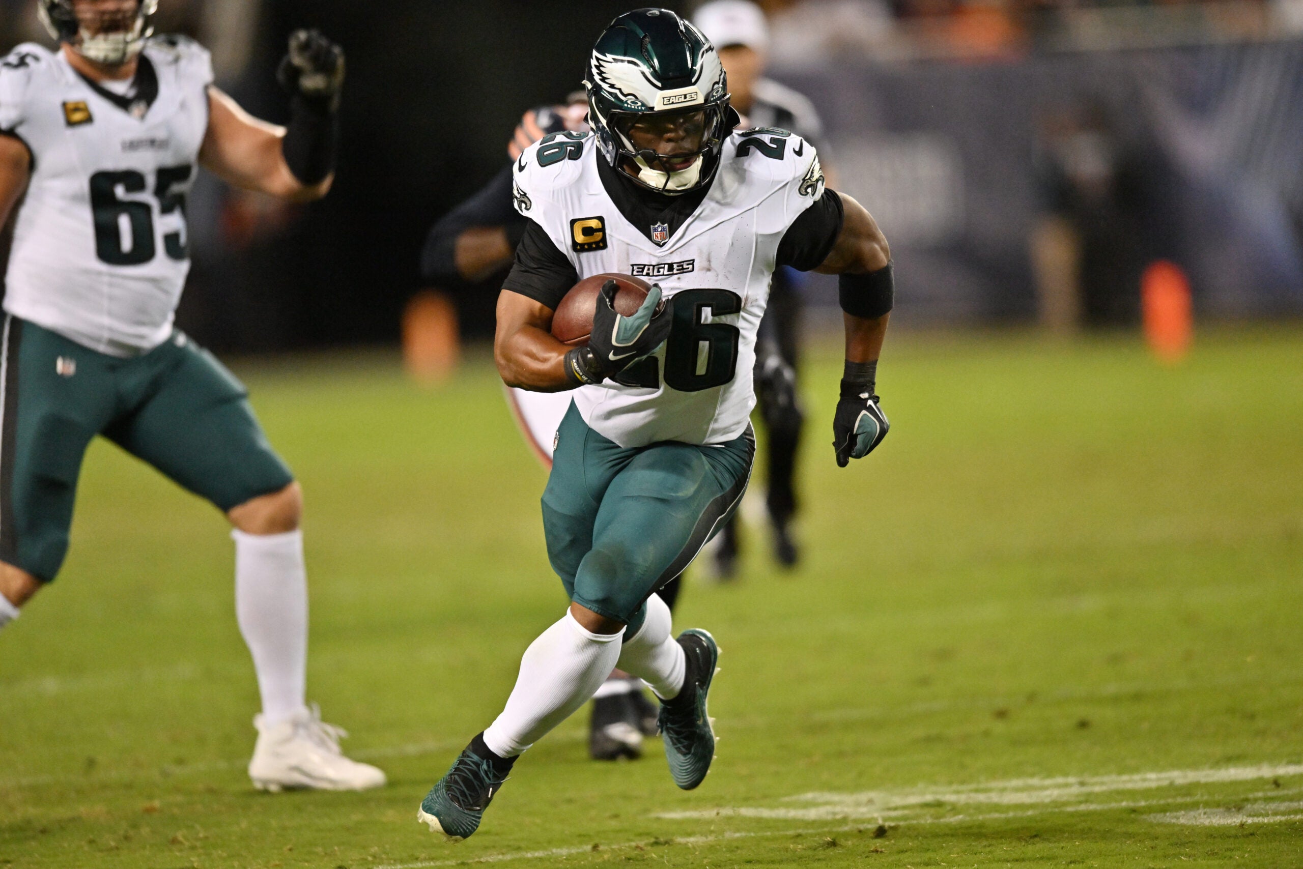 Sep 28, 2026; Chicago, Illinois, USA; Philadelphia Eagles running back Saquon Barkley (26) runs against the Chicago Bears during the first half at Soldier Field.