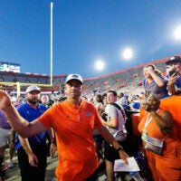 Sep 26, 2026; Gainesville, Florida, USA; Florida Gators head coach Jon Sumrall shakes hands while entering the team tunnel after a game against the Mississippi Rebels at Ben Hill Griffin Stadium.