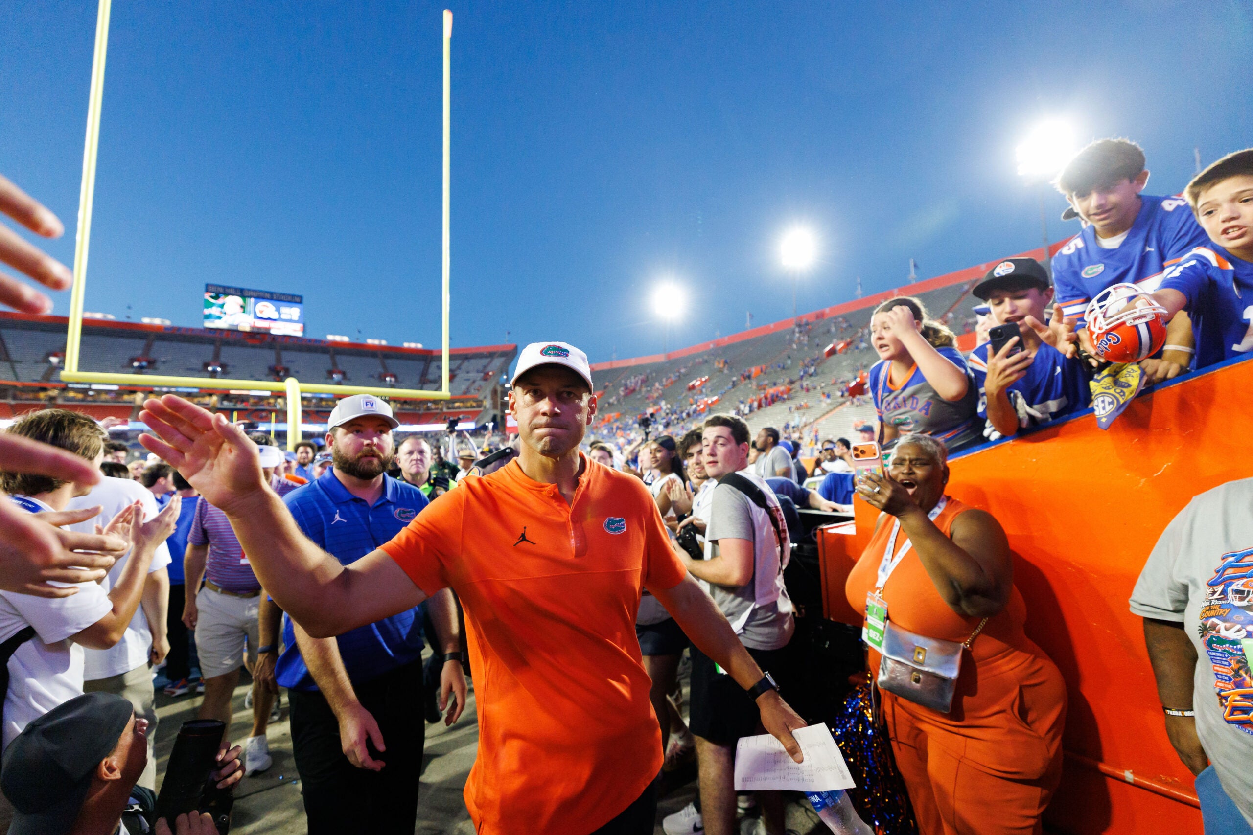 Sep 26, 2026; Gainesville, Florida, USA; Florida Gators head coach Jon Sumrall shakes hands while entering the team tunnel after a game against the Mississippi Rebels at Ben Hill Griffin Stadium.
