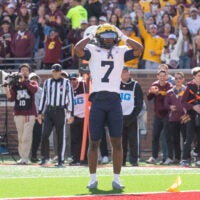 Oct 3, 2026; Minneapolis, Minnesota, USA; Michigan Wolverines defensive back Chris Bracy (7) gestures to the referee after being called for pass interference against Minnesota Golden Gophers wide receiver Noah Jennings (13) in the end zone during the first quarter at Huntington Bank Stadium.