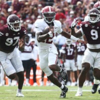 Oct 3, 2026; Starkville, Mississippi, USA; Alabama Crimson Tide quarterback Keelon Russell (12) runs against Mississippi State Bulldogs defensive line Jayson Jenkins (97) and defensive line Jaray Bledsoe (9) during the second half at Davis Wade Stadium at Scott Field.