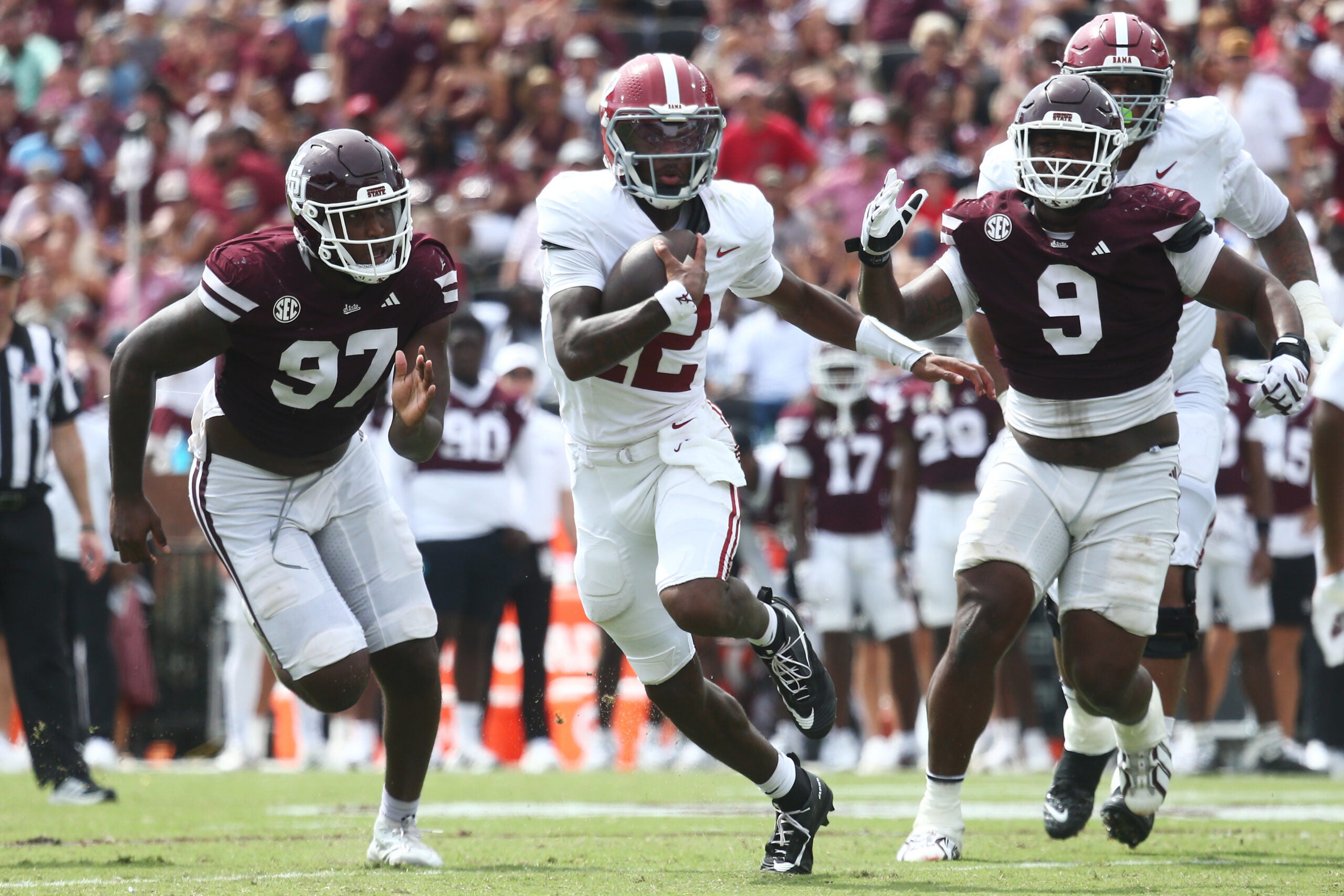 Oct 3, 2026; Starkville, Mississippi, USA; Alabama Crimson Tide quarterback Keelon Russell (12) runs against Mississippi State Bulldogs defensive line Jayson Jenkins (97) and defensive line Jaray Bledsoe (9) during the second half at Davis Wade Stadium at Scott Field.