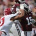 Oct 3, 2026; Starkville, Mississippi, USA; Mississippi State Bulldogs quarterback Parker Puckett (15) looks to pass under pressure from Alabama Crimson Tide linebacker Xavier Griffin (11) during the second half at Davis Wade Stadium at Scott Field.