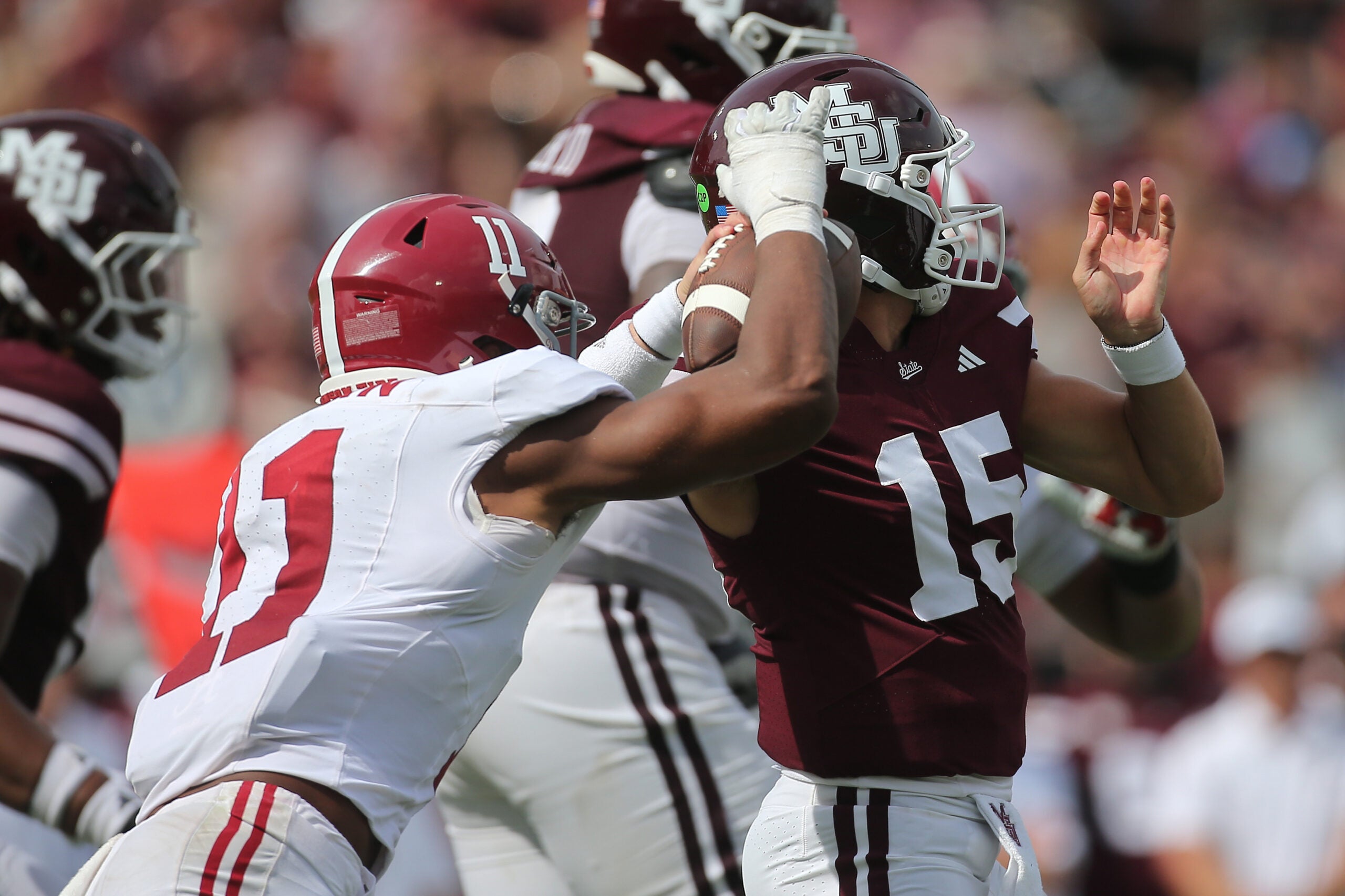 Oct 3, 2026; Starkville, Mississippi, USA; Mississippi State Bulldogs quarterback Parker Puckett (15) looks to pass under pressure from Alabama Crimson Tide linebacker Xavier Griffin (11) during the second half at Davis Wade Stadium at Scott Field.