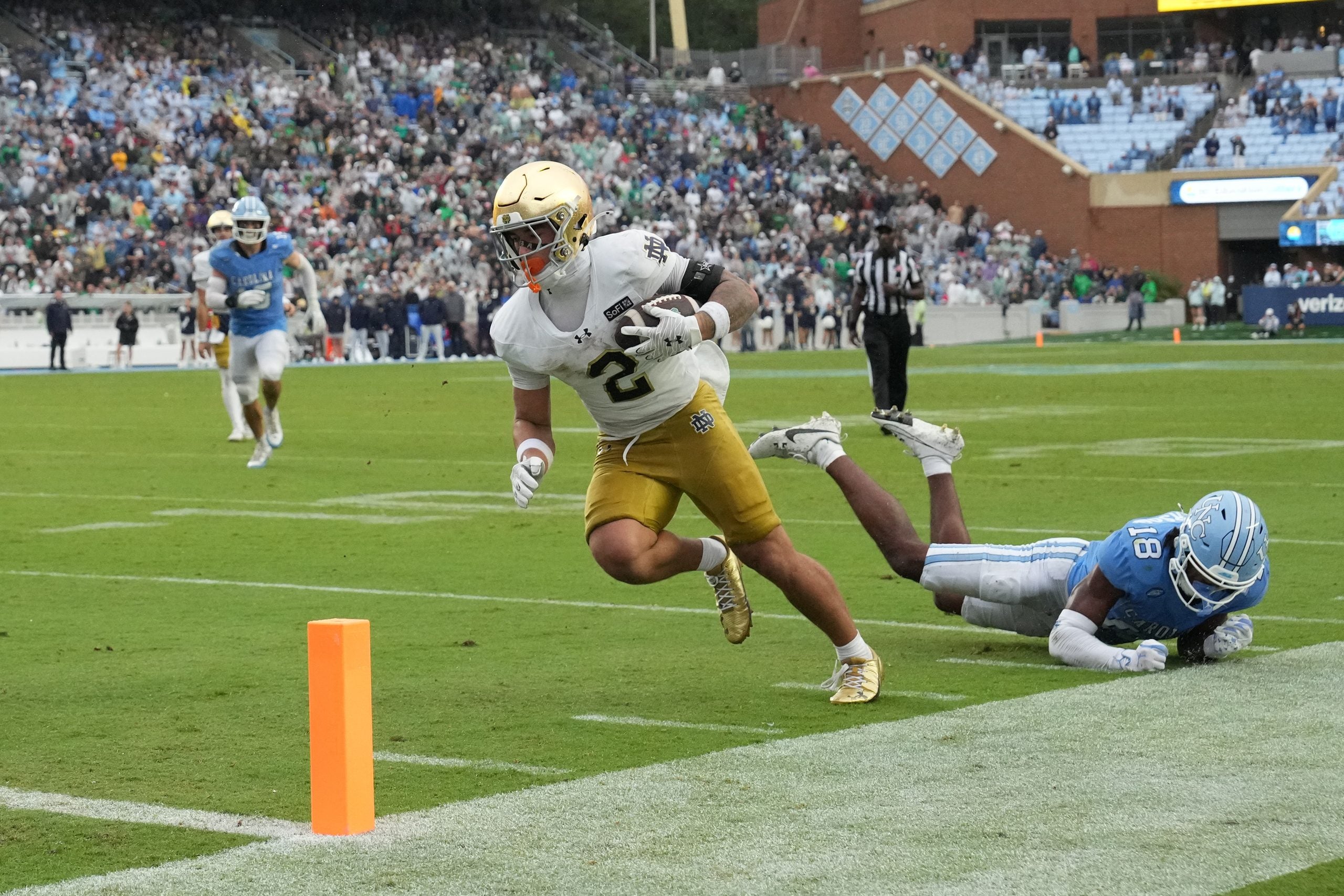 Oct 3, 2026; Chapel Hill, North Carolina, USA; Notre Dame Fighting Irish running back Nolan James Jr. (2) socres a touchdown as North Carolina Tar Heels defensive back Jaiden Patterson (18) defends in the second half at Kenan Stadium.