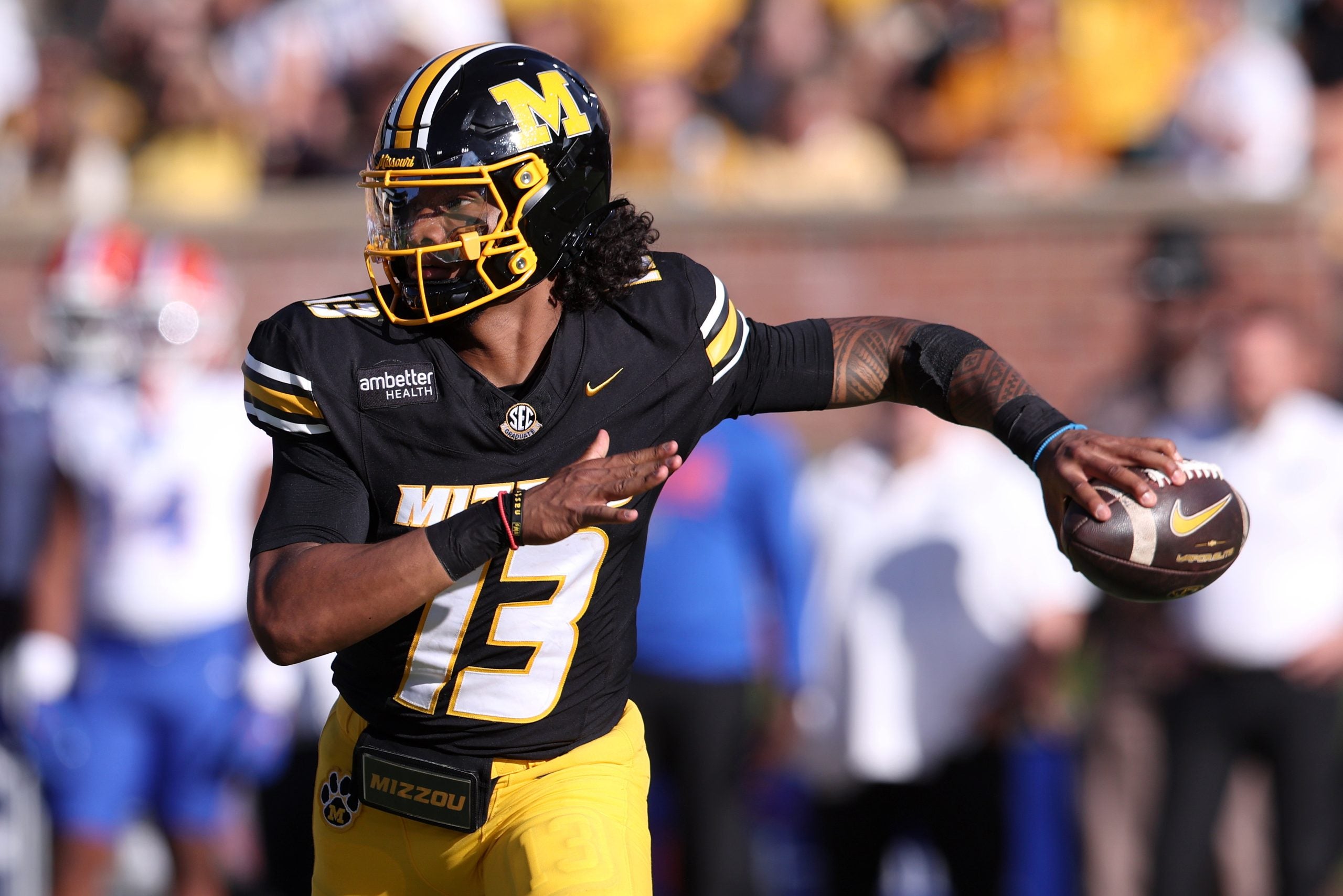 Oct 3, 2026; Columbia, Missouri, USA; Missouri Tigers quarterback Austin Simmons (13) looks to throw in the third quarter against the Florida Gators at Faurot Field at Memorial Stadium.