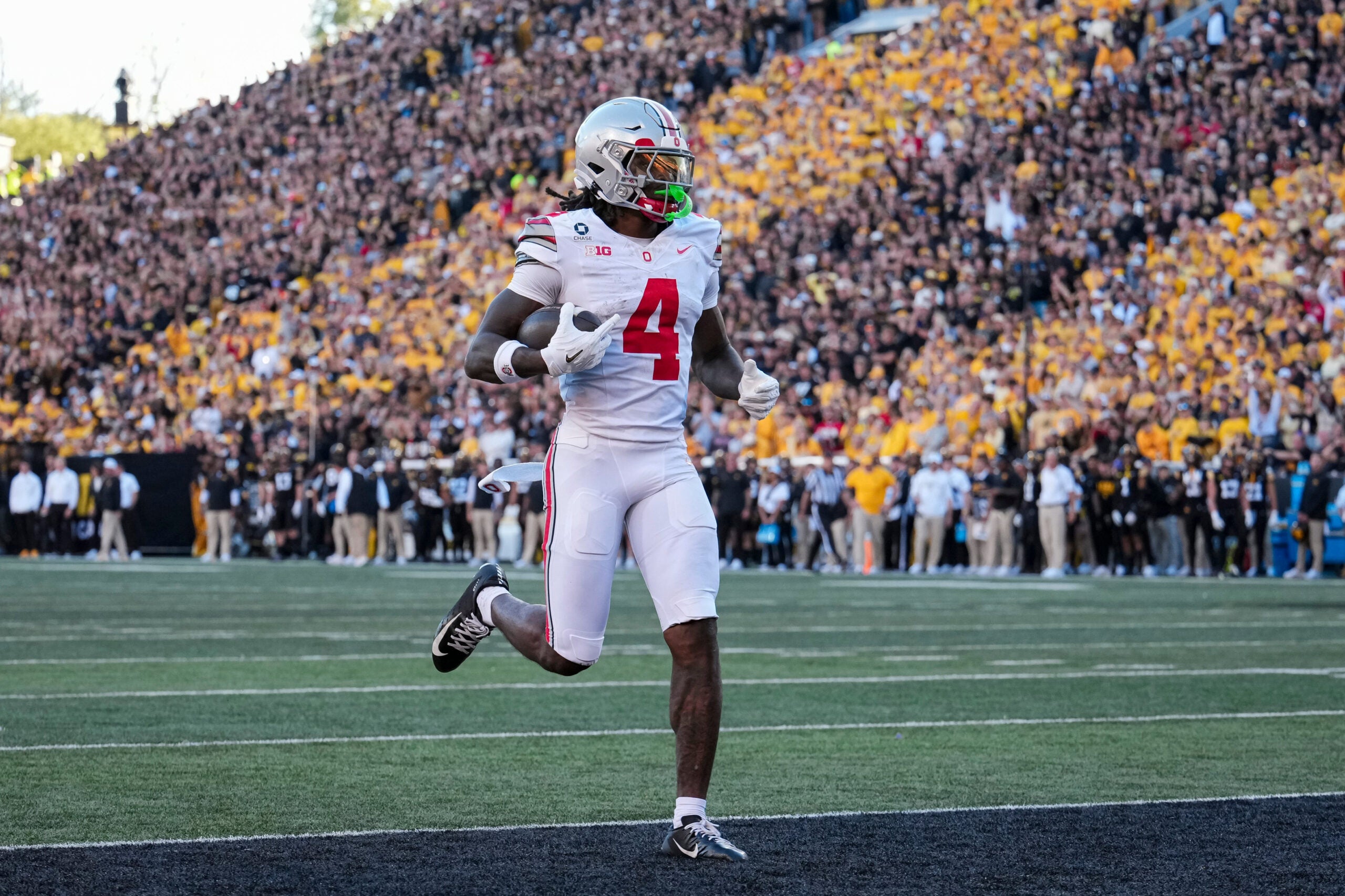 Ohio State Buckeyes wide receiver Jeremiah Smith (4) scores a touchdown, breaking the school's all-time record, during the NCAA football game against the Iowa Hawkeyes at Kinnick Stadium in Iowa City on Oct. 3, 2026. Ohio State on 31-14.
