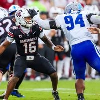 Oct 3, 2026; Columbia, South Carolina, USA; South Carolina Gamecocks quarterback LaNorris Sellers (16) eludes the sack of Kentucky Wildcats defensive lineman Tavion Gadson (94) in the second half at Williams-Brice Stadium.