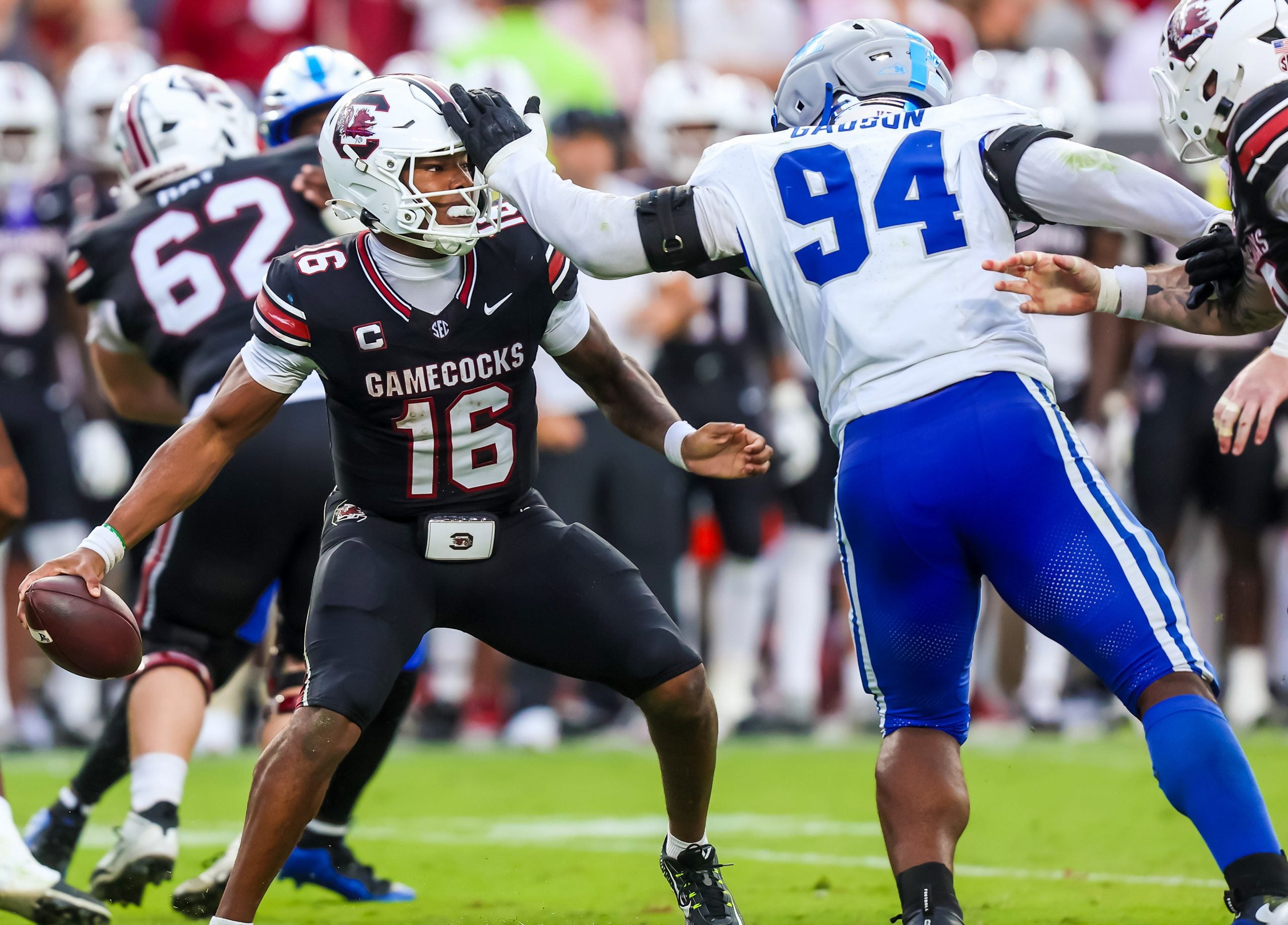 Oct 3, 2026; Columbia, South Carolina, USA; South Carolina Gamecocks quarterback LaNorris Sellers (16) eludes the sack of Kentucky Wildcats defensive lineman Tavion Gadson (94) in the second half at Williams-Brice Stadium.