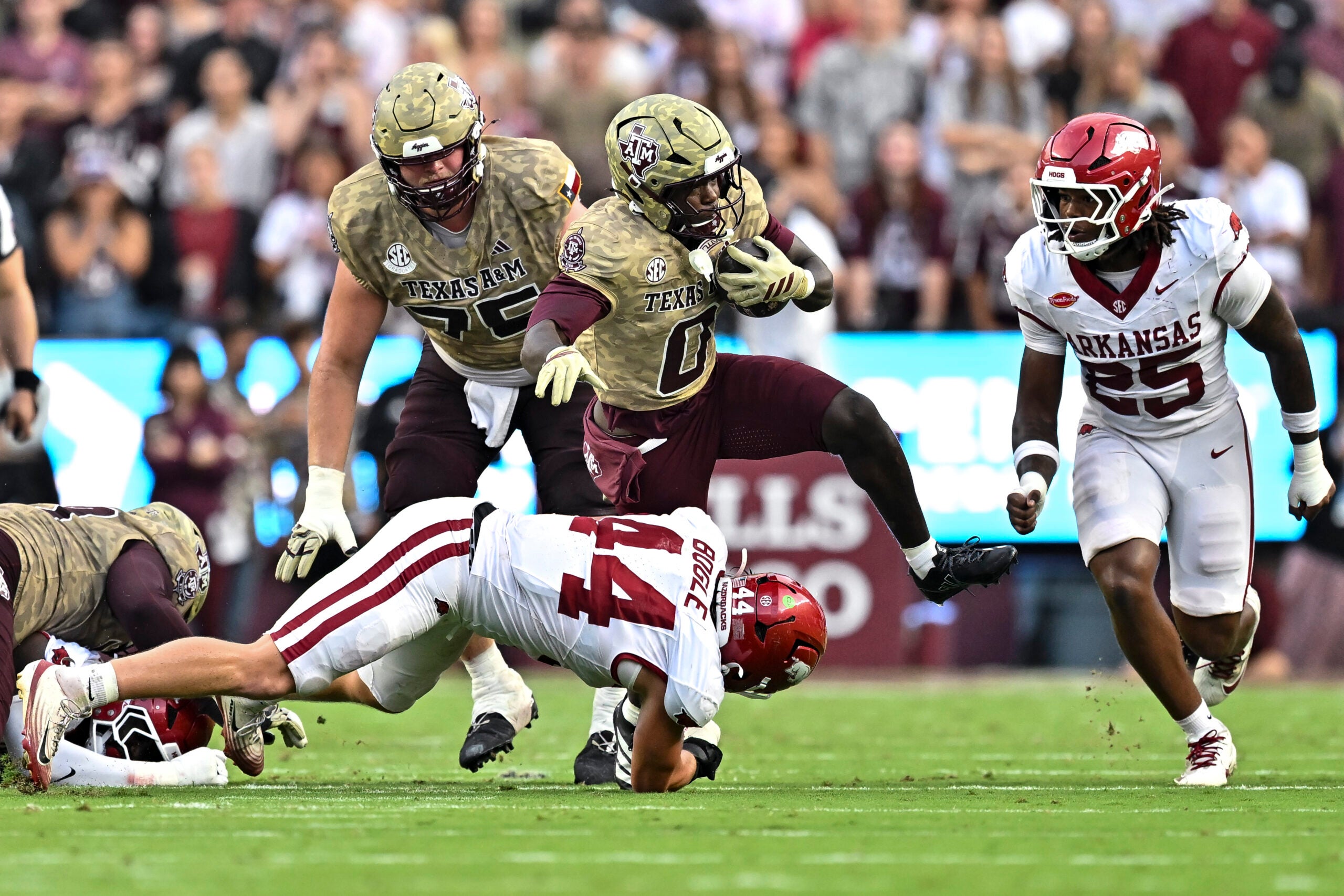 Oct 3, 2026; College Station, Texas, USA; Texas A&M Aggies running back KJ Edwards (0) runs the ball as Arkansas Razorbacks linebacker Ben Bogle (44) attempts a tackle during the first half at Kyle Field.