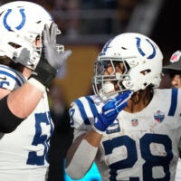Oct 4, 2026; Tottenham, ENG; Indianapolis Colts running back Jonathan Taylor (28) celebrates his touchdown against the Washington Commanders with guard Quenton Nelson (56) during the third quarter at Tottenham Hotspur Stadium.