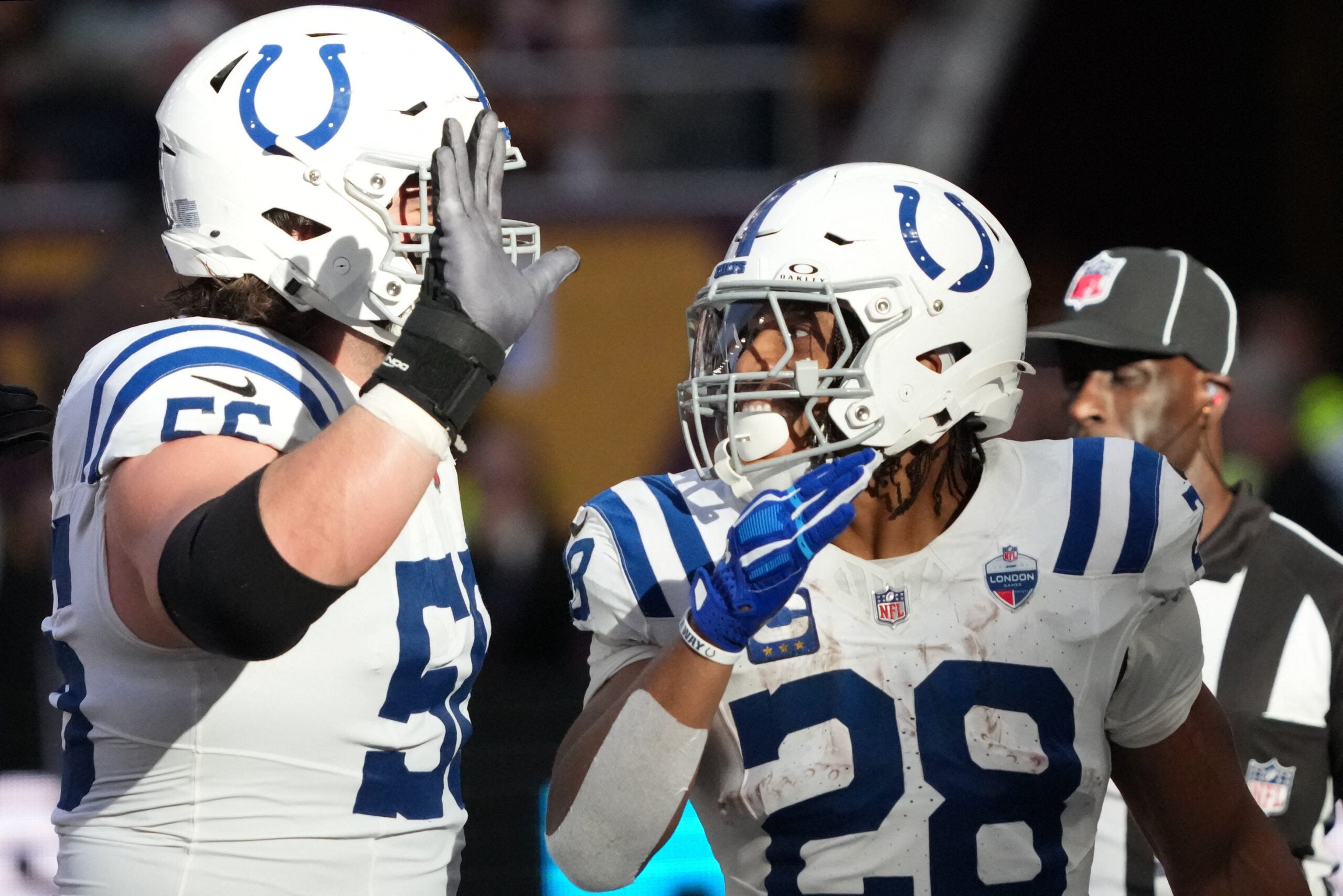 Oct 4, 2026; Tottenham, ENG; Indianapolis Colts running back Jonathan Taylor (28) celebrates his touchdown against the Washington Commanders with guard Quenton Nelson (56) during the third quarter at Tottenham Hotspur Stadium.