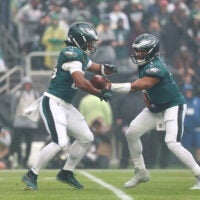 Oct 4, 2026; Philadelphia, Pennsylvania, USA; Philadelphia Eagles quarterback Jalen Hurts (1) hands the ball off to running back Saquon Barkley (26) against the Los Angeles Rams during the first quarter at Lincoln Financial Field.