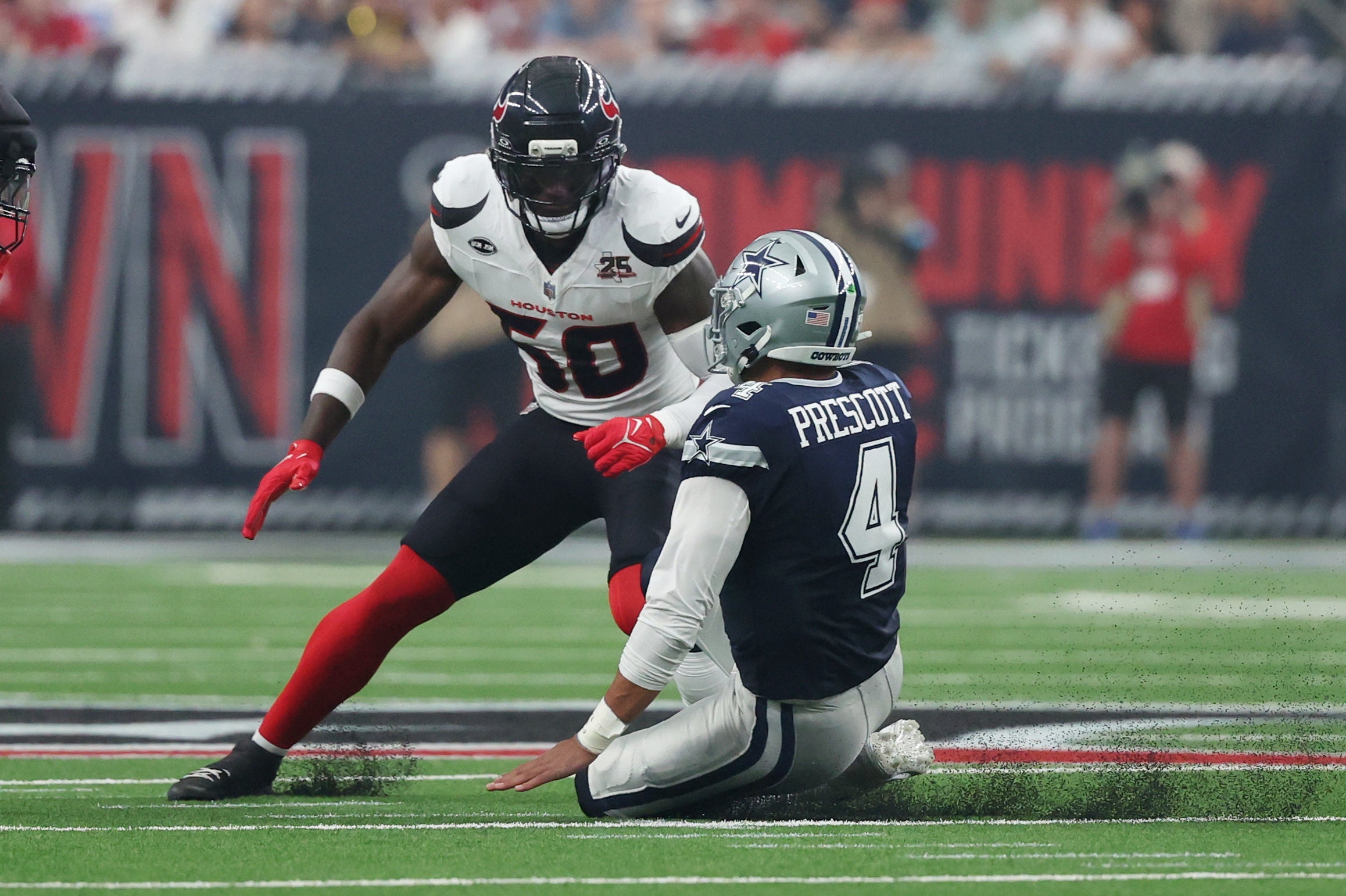 Oct 4, 2026; Houston, Texas, USA; Houston Texans Kenneth Murray Jr. (50) makes a tackle on Dallas Cowboys quarterback Dak Prescott (4) during the first quarter at Reliant Stadium.